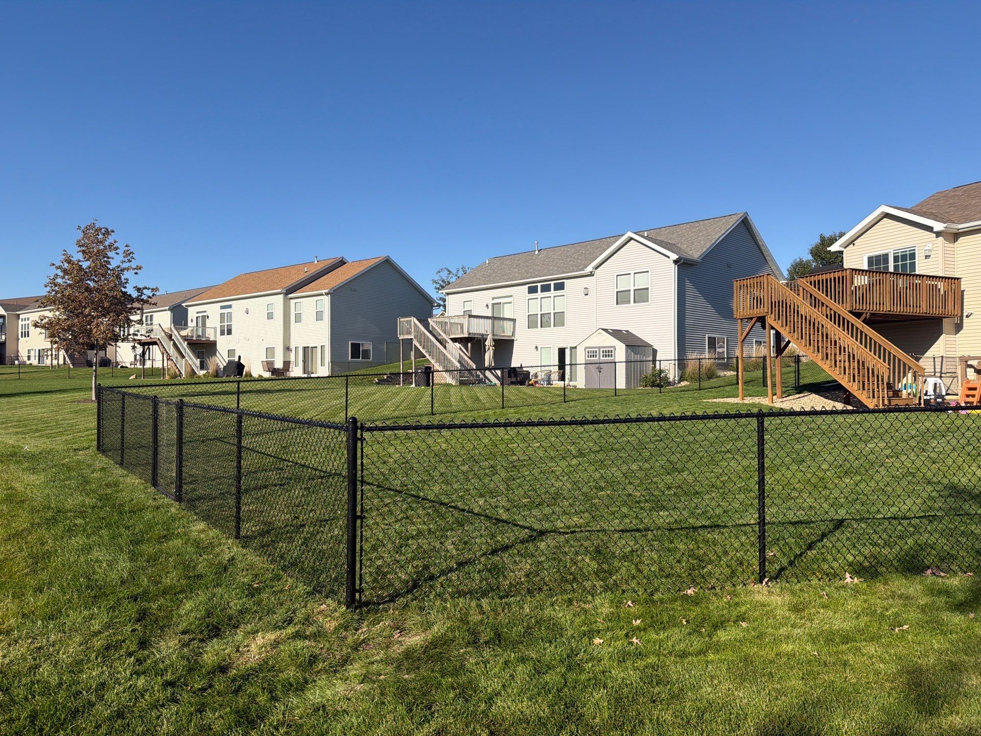 Black Vinyl-Coated Chain Link Fence Installation in Cedar Falls by Perfect Picket Fence and Stain