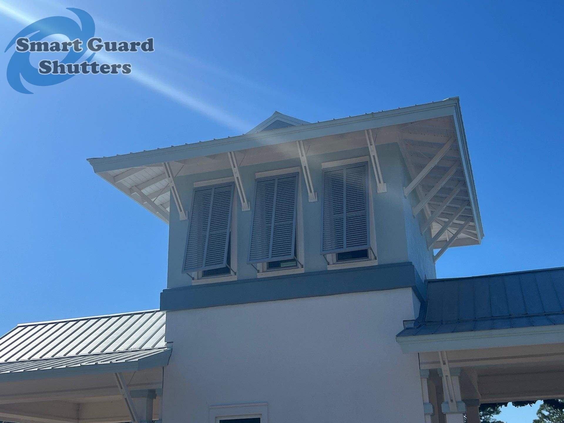 Decorative Bahama Shutters in Window Grey by Smart Guard Shutters