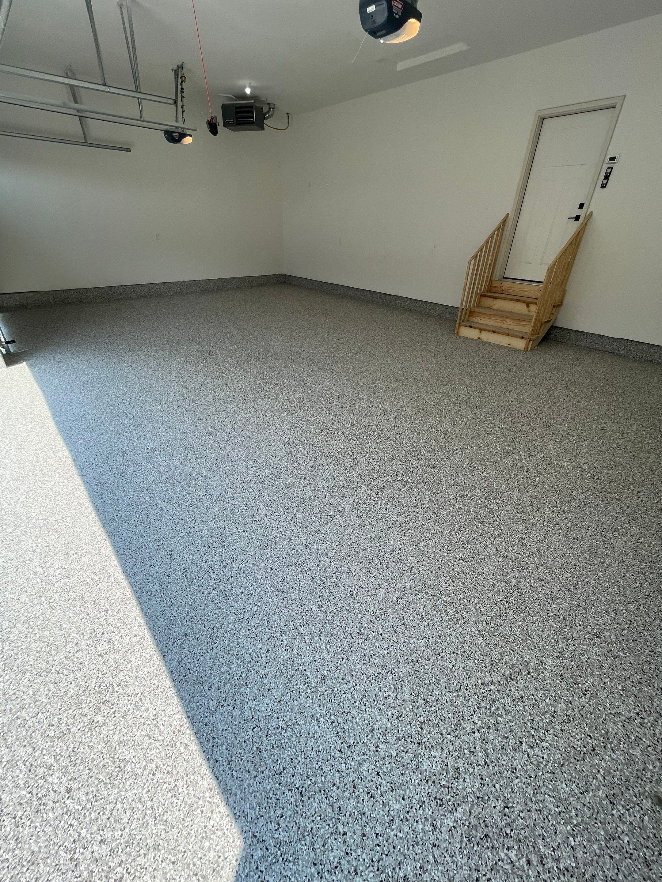 Grey Speckled Garage Floor Coating in Sioux Falls by Select Painting, Coatings & Garage Cabinets