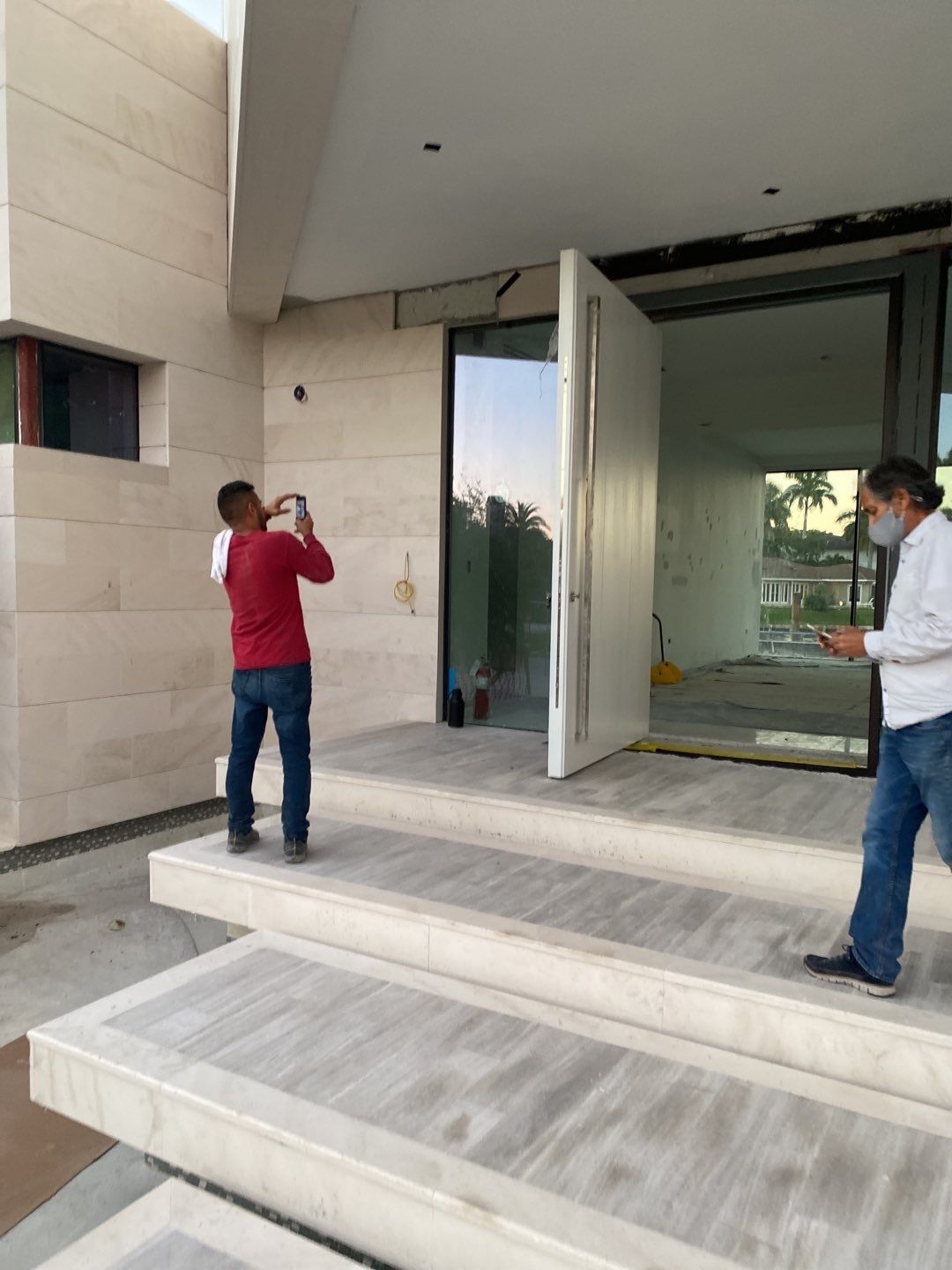 Custom Material Pivot Door installation by Impact Precious Windows and Doors