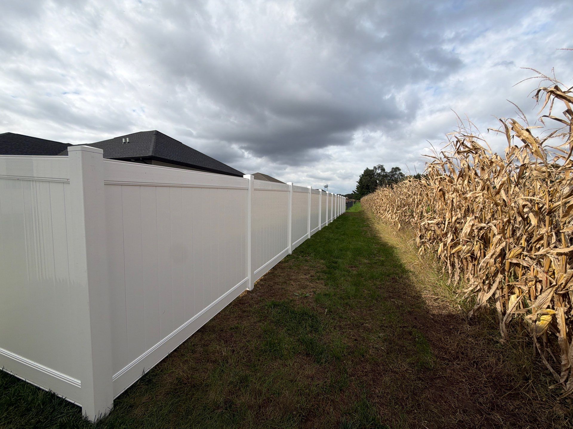 Residential White Vinyl Privacy Fence Installation in Janesville by Perfect Picket Fence and Stain
