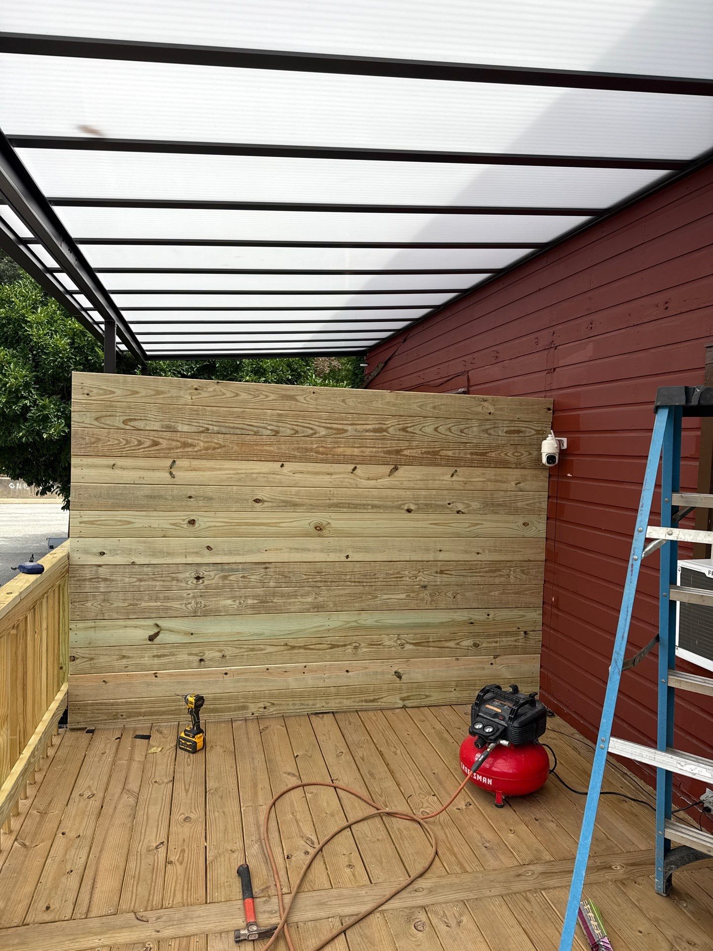 Roof sunspace deck  by Cousins Roofing Siding & Decks