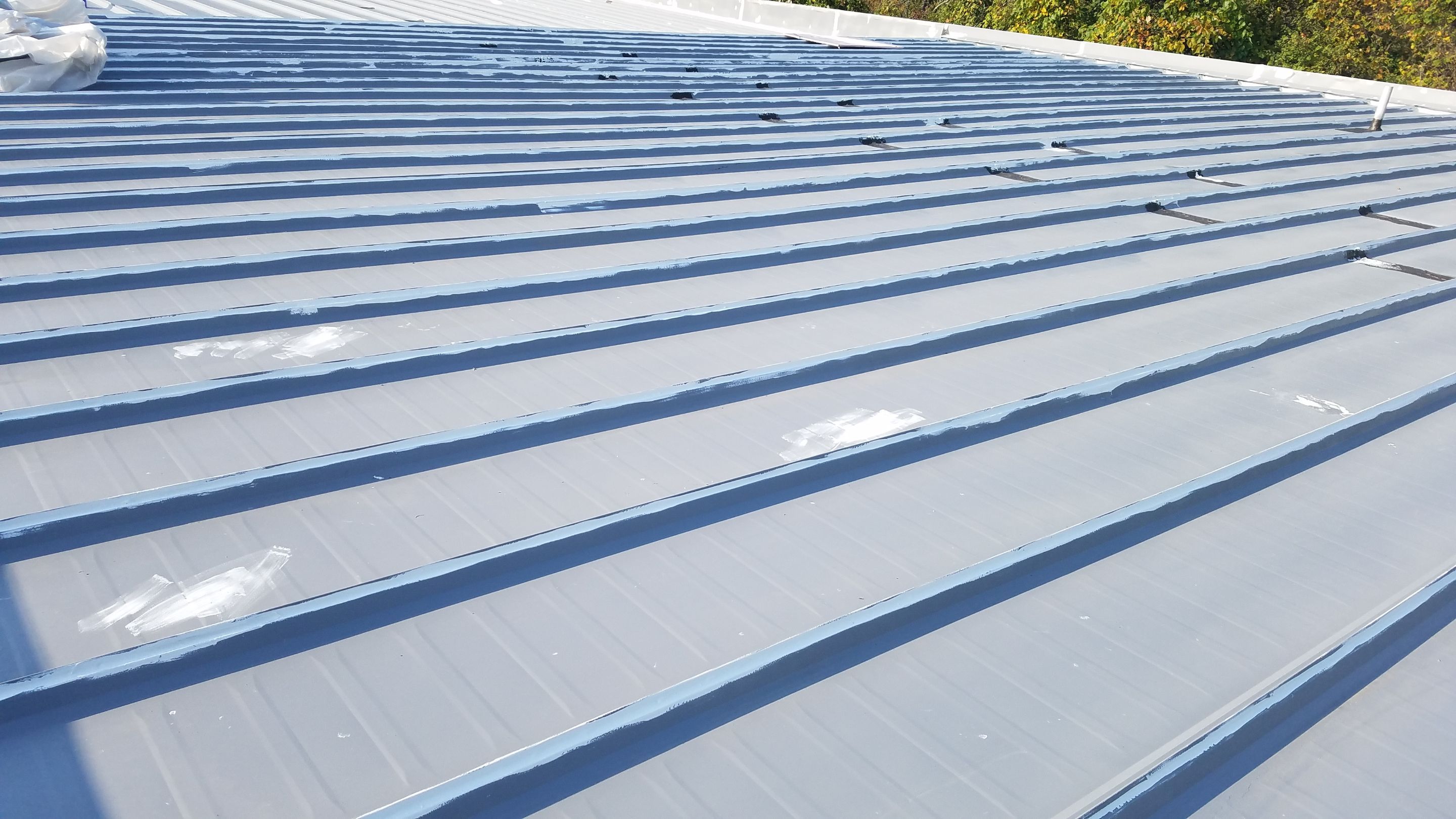 Commercial Metal Roof Coating by Gold Star Roofing LLC