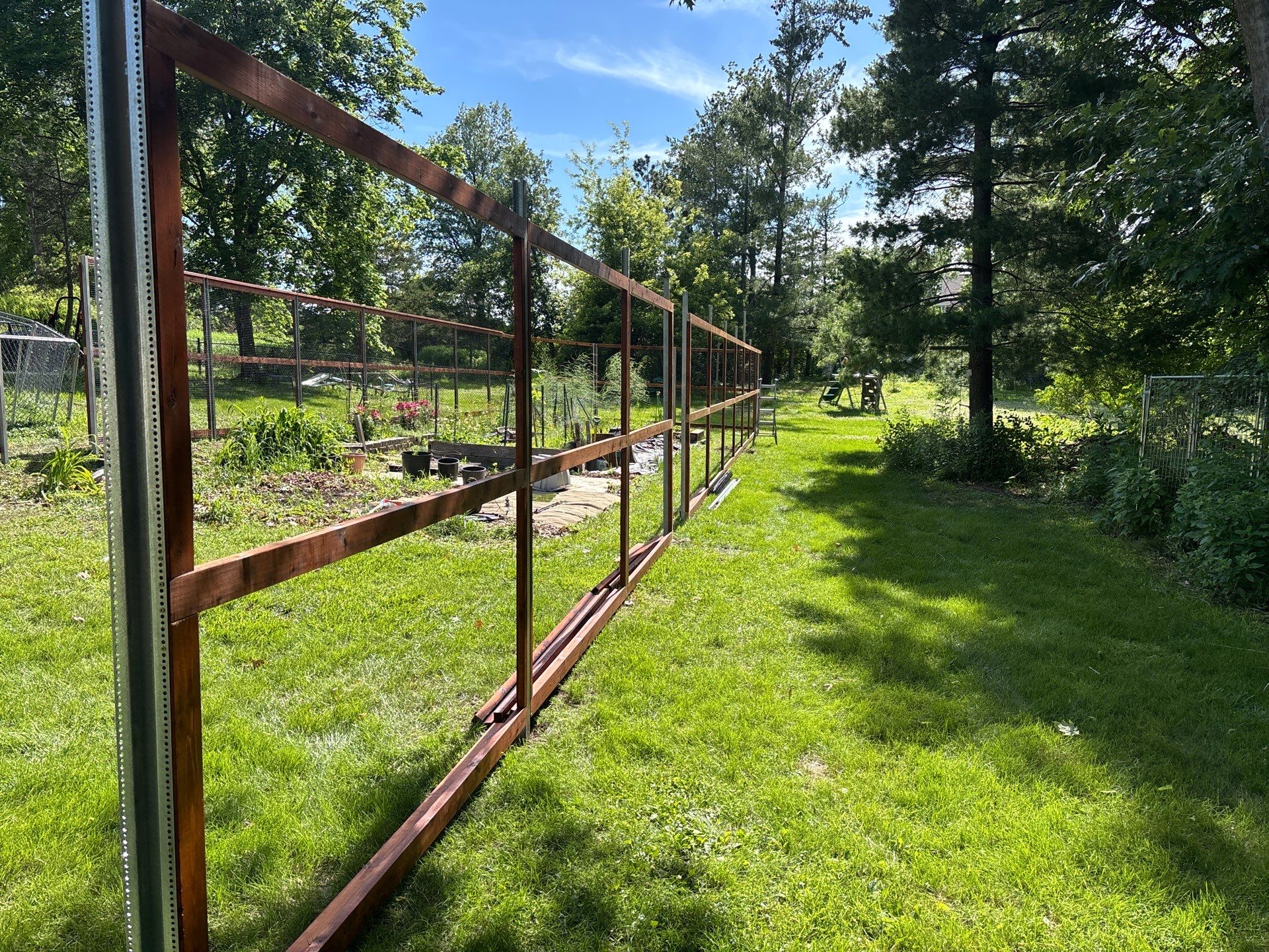 Stained Cedar Mahogany Garden Fence and Raised Bed Enclosure in Cedar Falls by Perfect Picket Fence and Stain