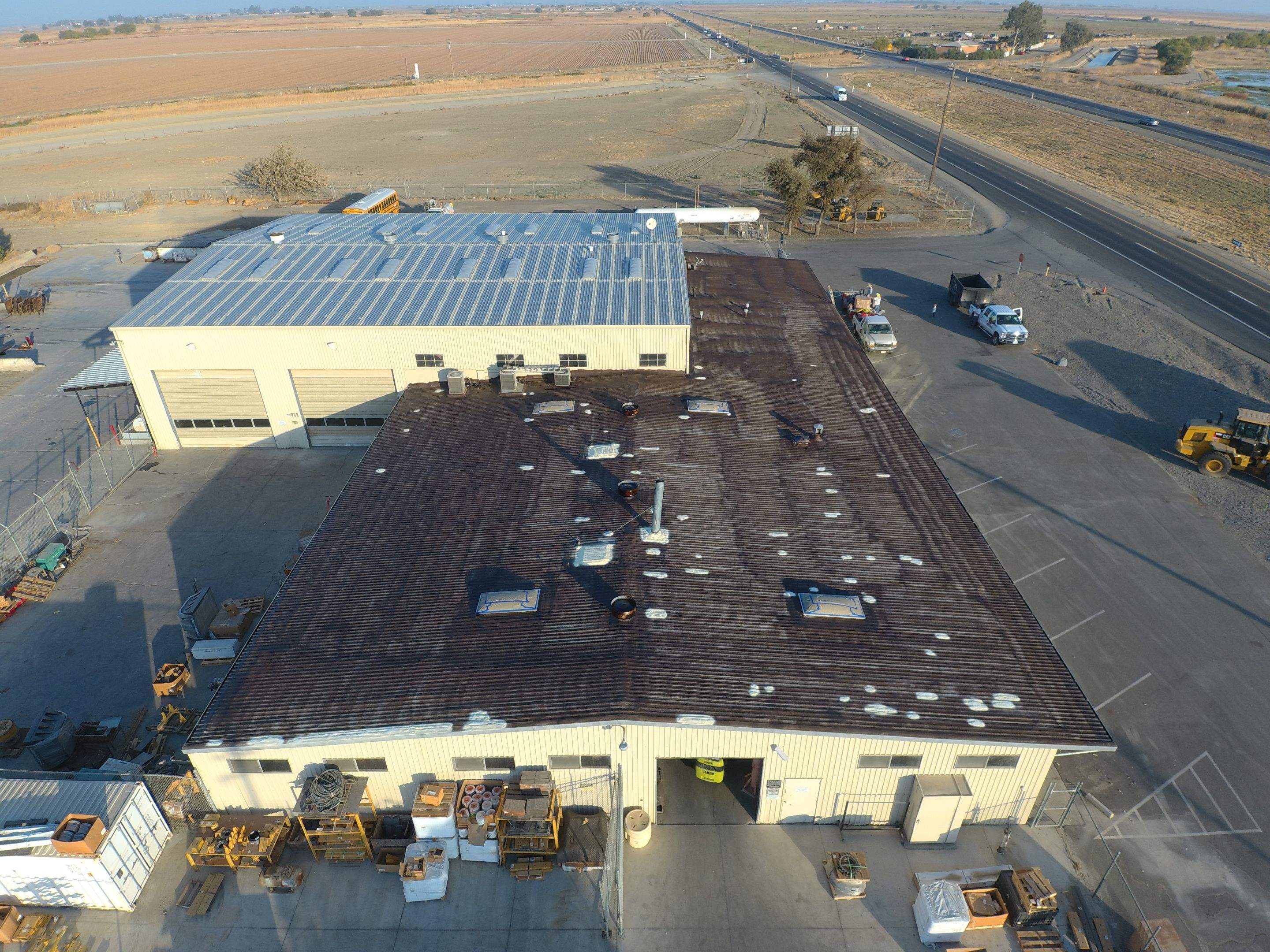 Metal roof restoration on commercial roof using Conklin Benchmark/ PUMA XL acrylic coatings over metal and foam by Straight Edge Roofing Inc