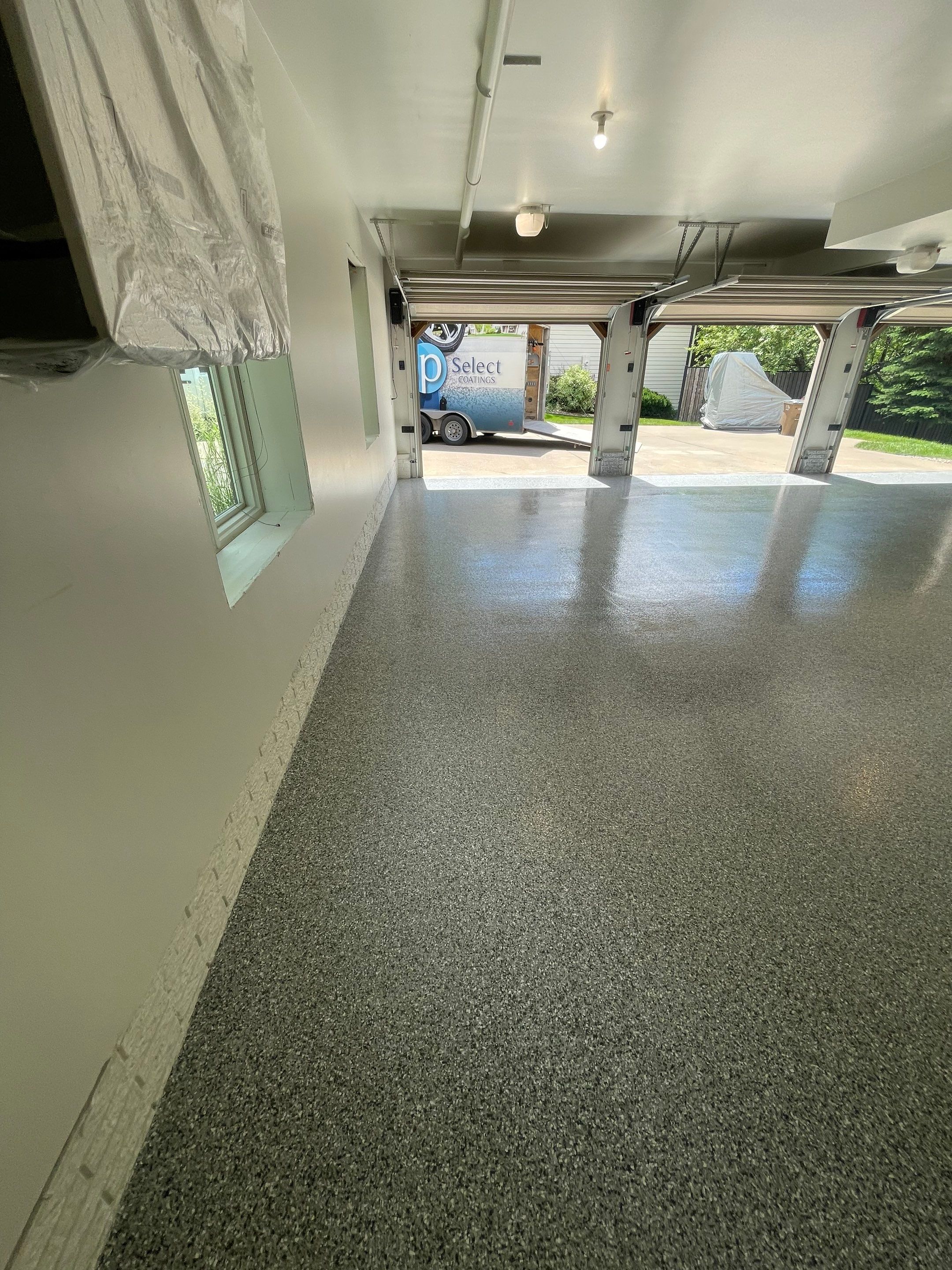 Gray Speckled Epoxy Garage Floor Coating in Sioux Falls by Select Painting, Coatings & Garage Cabinets