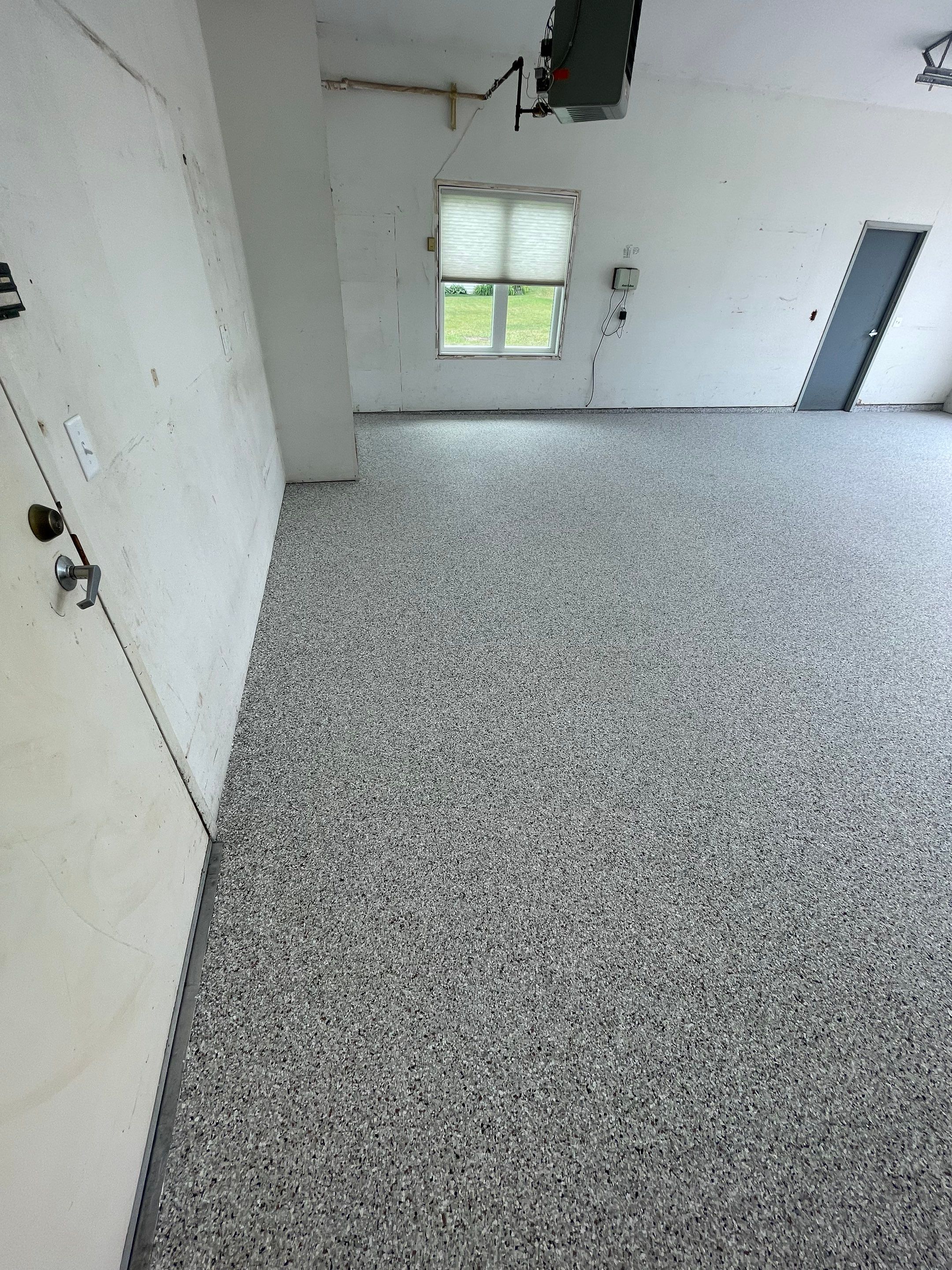 Coyote Flake Concrete Coating for Sioux Falls Garage by Select Painting, Coatings & Garage Cabinets