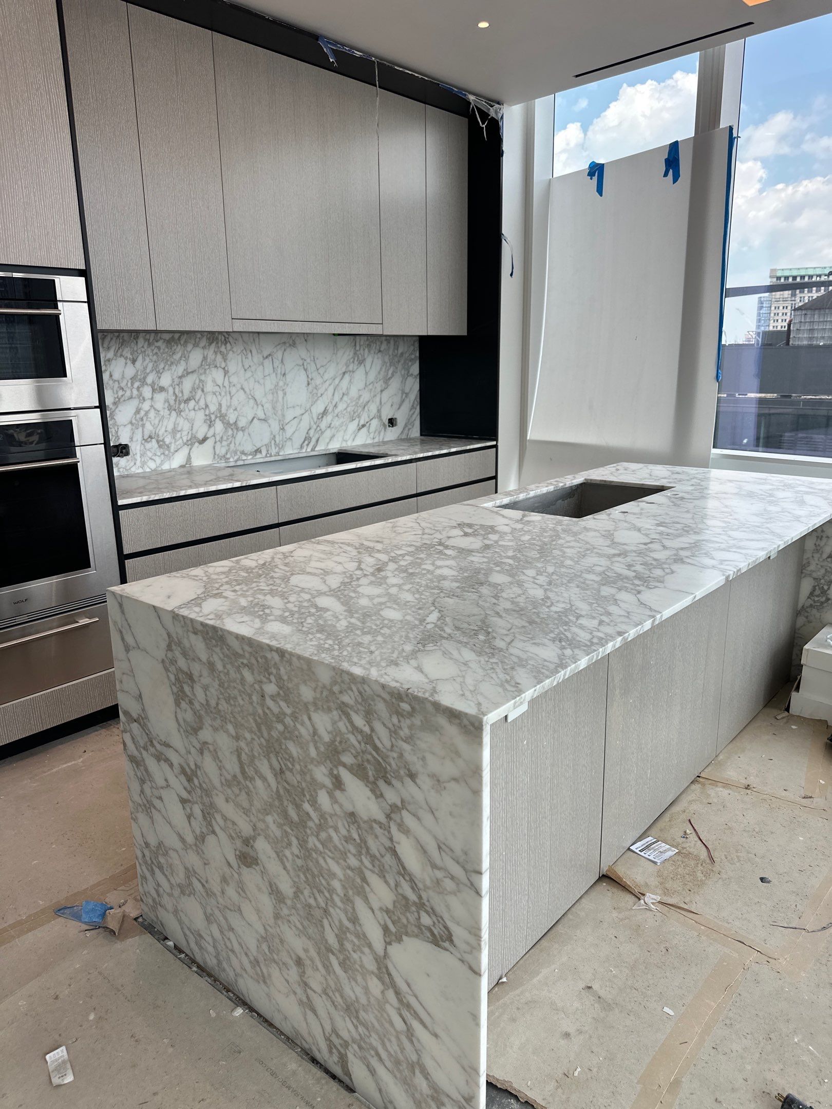 Kitchen Countertop with backsplash and Island top with mitered waterfalls by NC Stone And Tiles