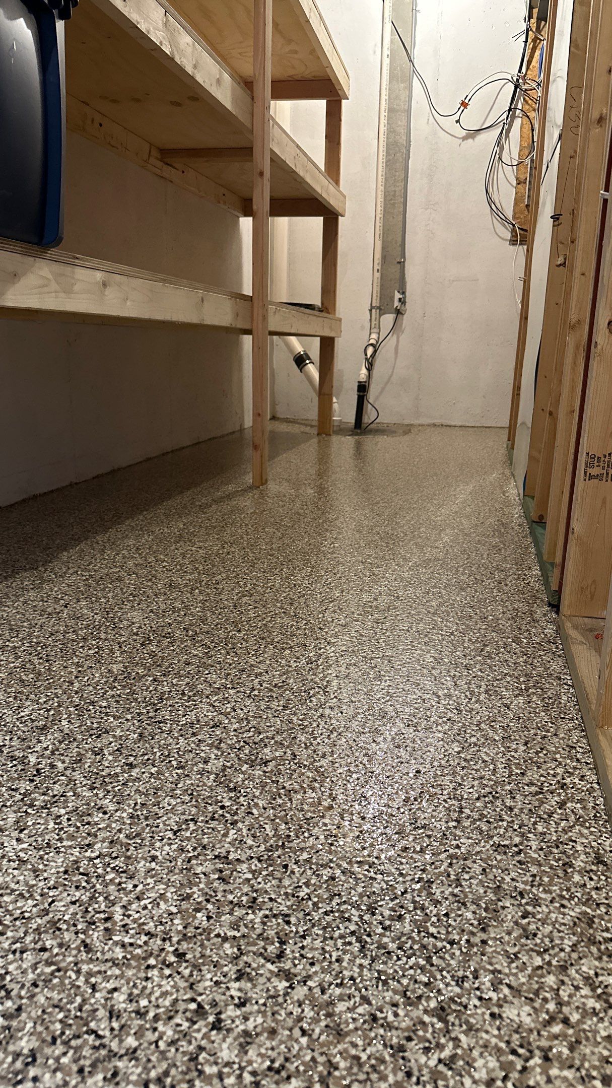 Shelly E. chose a riverbed flake floor for their basement  by Banner Garage