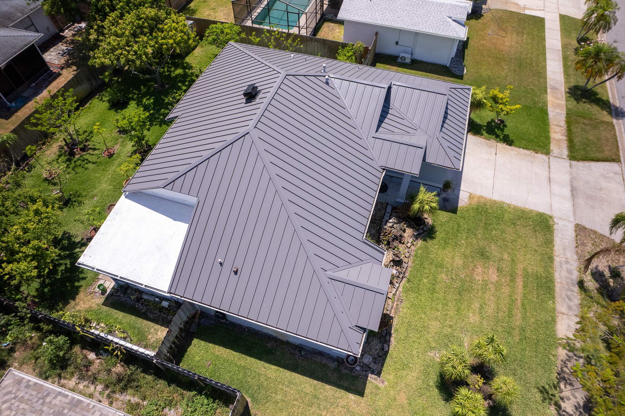 Complete Metal Roof Replacement and Seamless Gutter Installation in Melbourne by Wiedmann Construction & Roofing