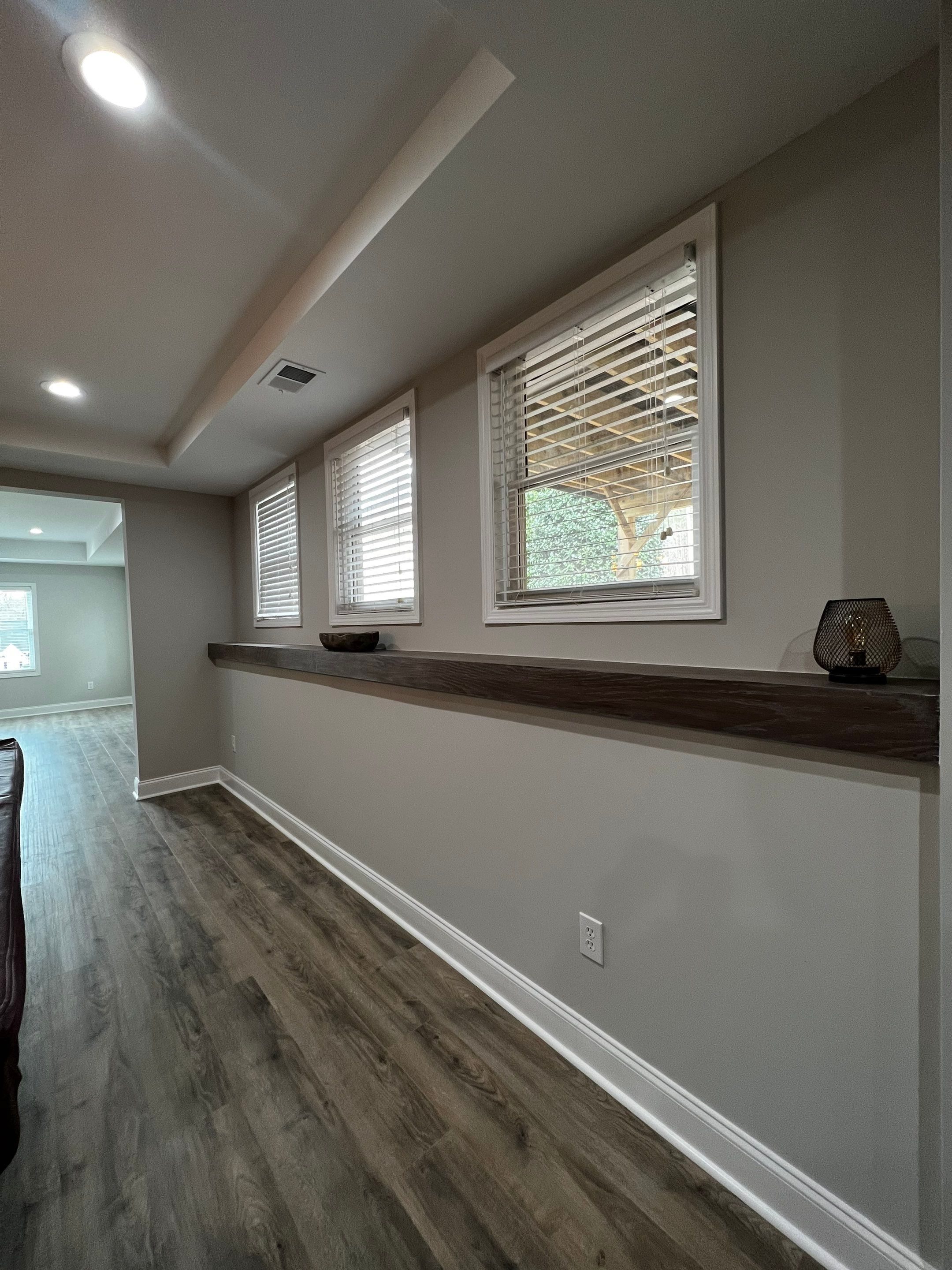 Modern Basement Remodeling in Woodstock with Custom Live-Edge Bar by Swift Home Renovations