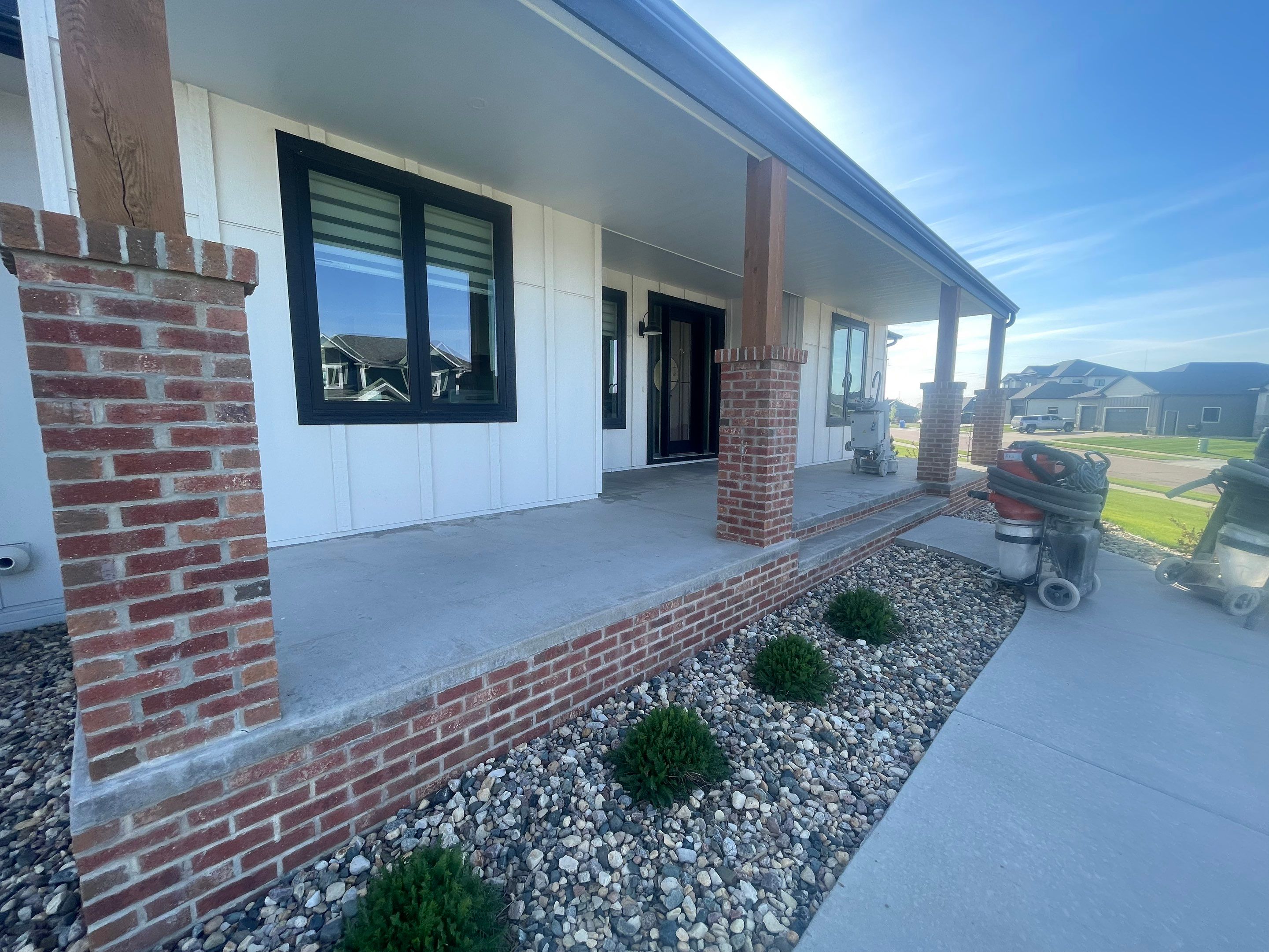 Grey Speckled Concrete Porch Coating for Sioux Falls Home by Select Painting, Coatings & Garage Cabinets