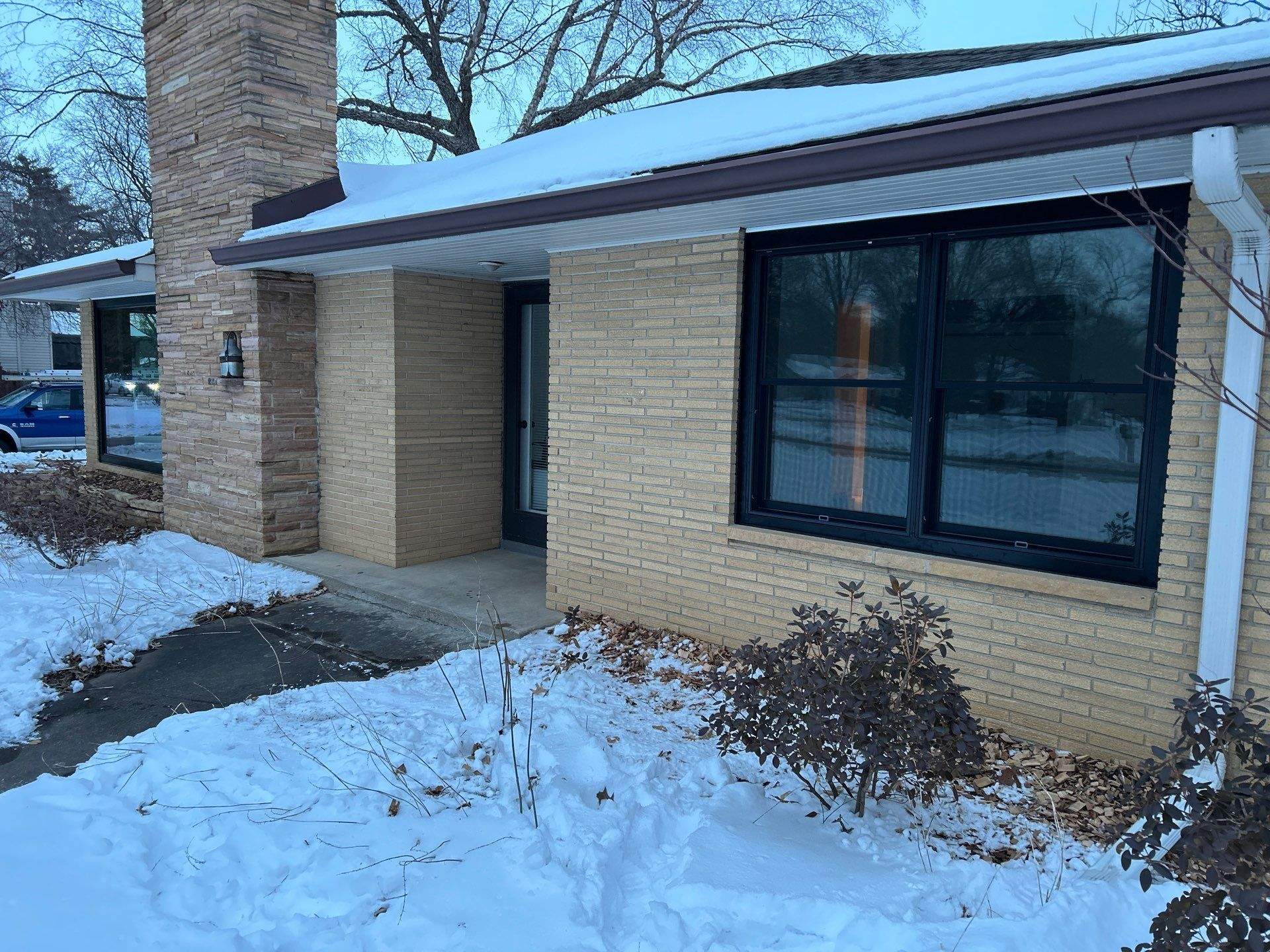 Black-Frame Pella Lifestyle Upgrade on a Partial Brick Home by United Windows and Siding LLC