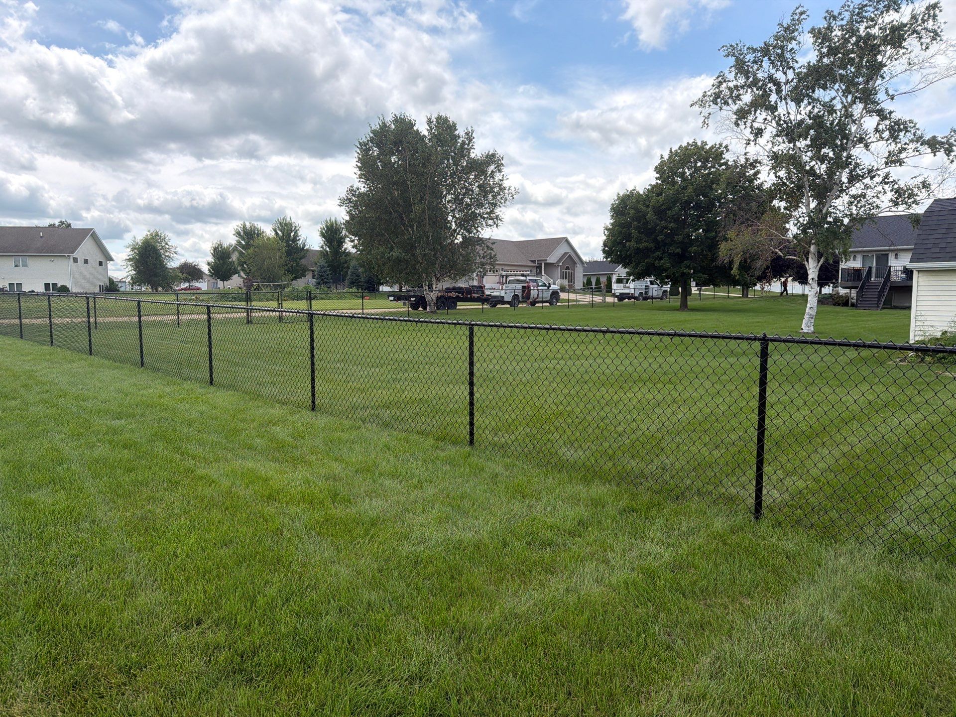 Black Vinyl-Coated Chain Link Fence Installation in Fairbank by Perfect Picket Fence and Stain
