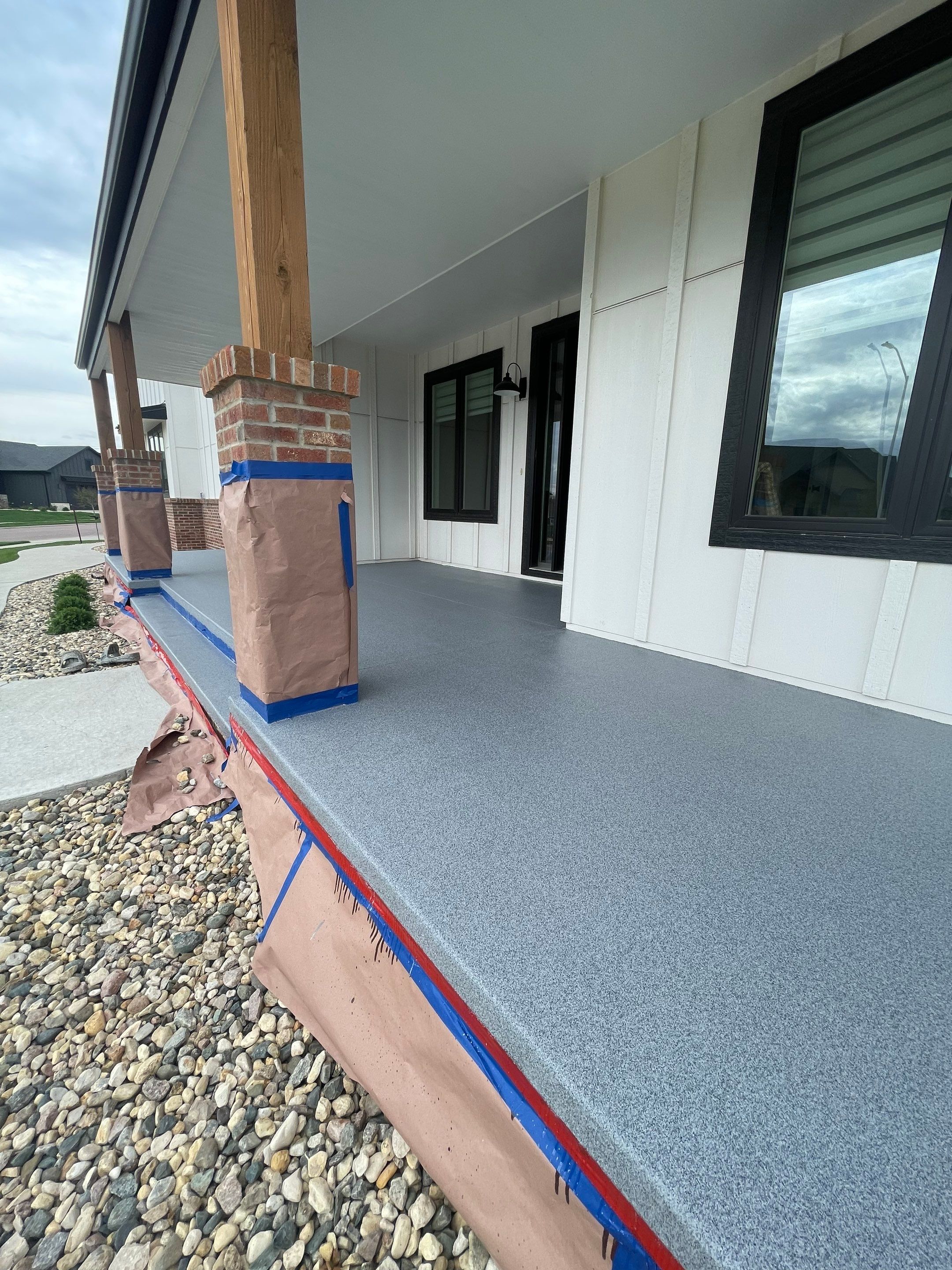 Grey Speckled Concrete Porch Coating for Sioux Falls Home by Select Painting, Coatings & Garage Cabinets