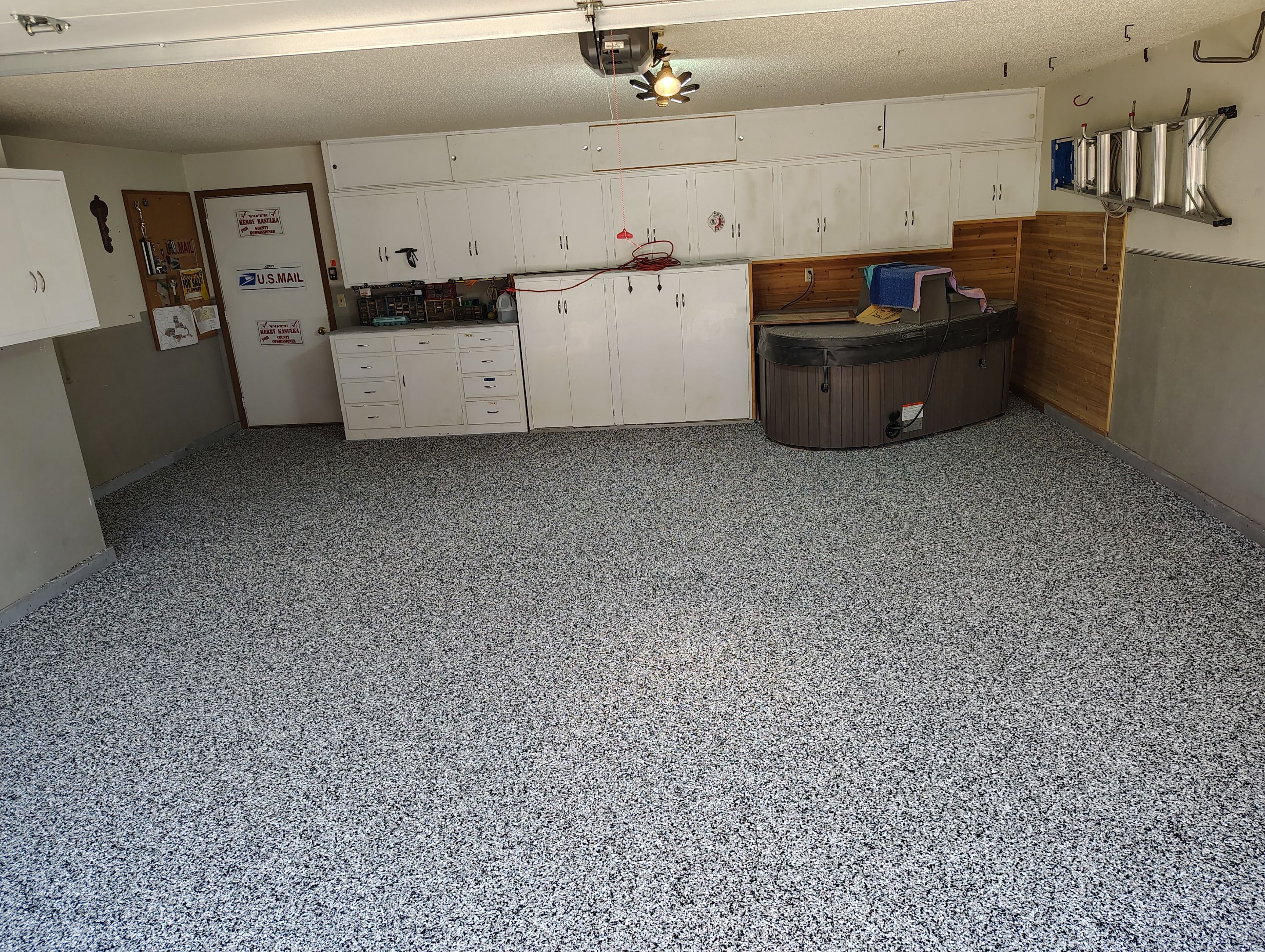 Domino Flake Garage Floor Coating Installation in Sioux Falls by Select Painting, Coatings & Garage Cabinets