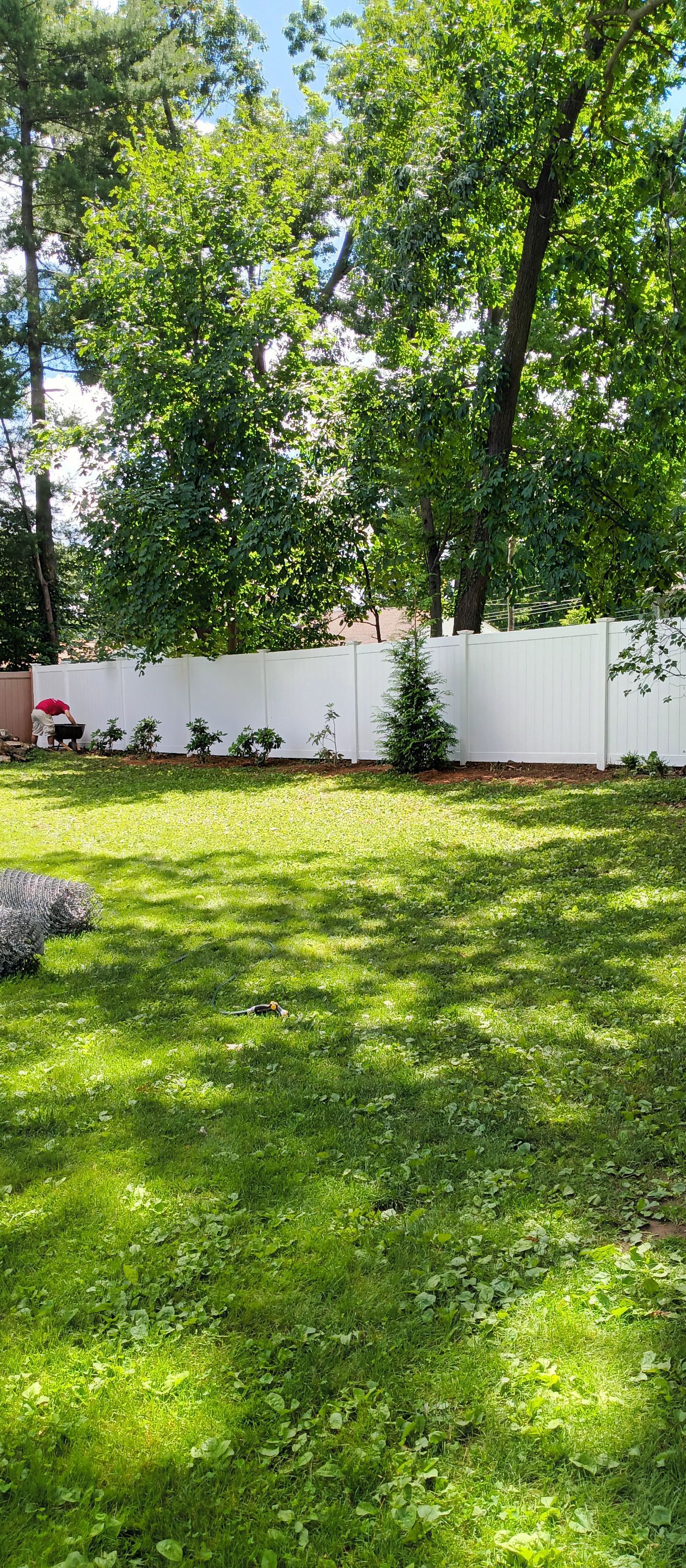 New Vinyl Privacy fence with matching drive gate in white by DiGiorgi Roofing and Siding Inc