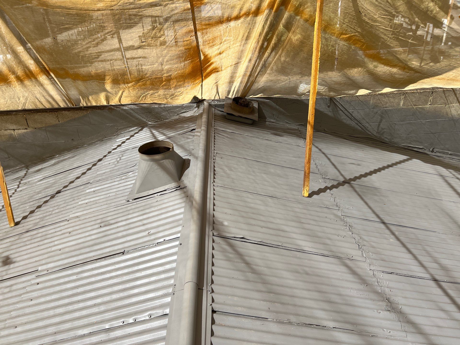 Spray foam and coatings using Conklin Benchmark/ PUMA XL acrylic coatings over metal and foam by Straight Edge Roofing Inc