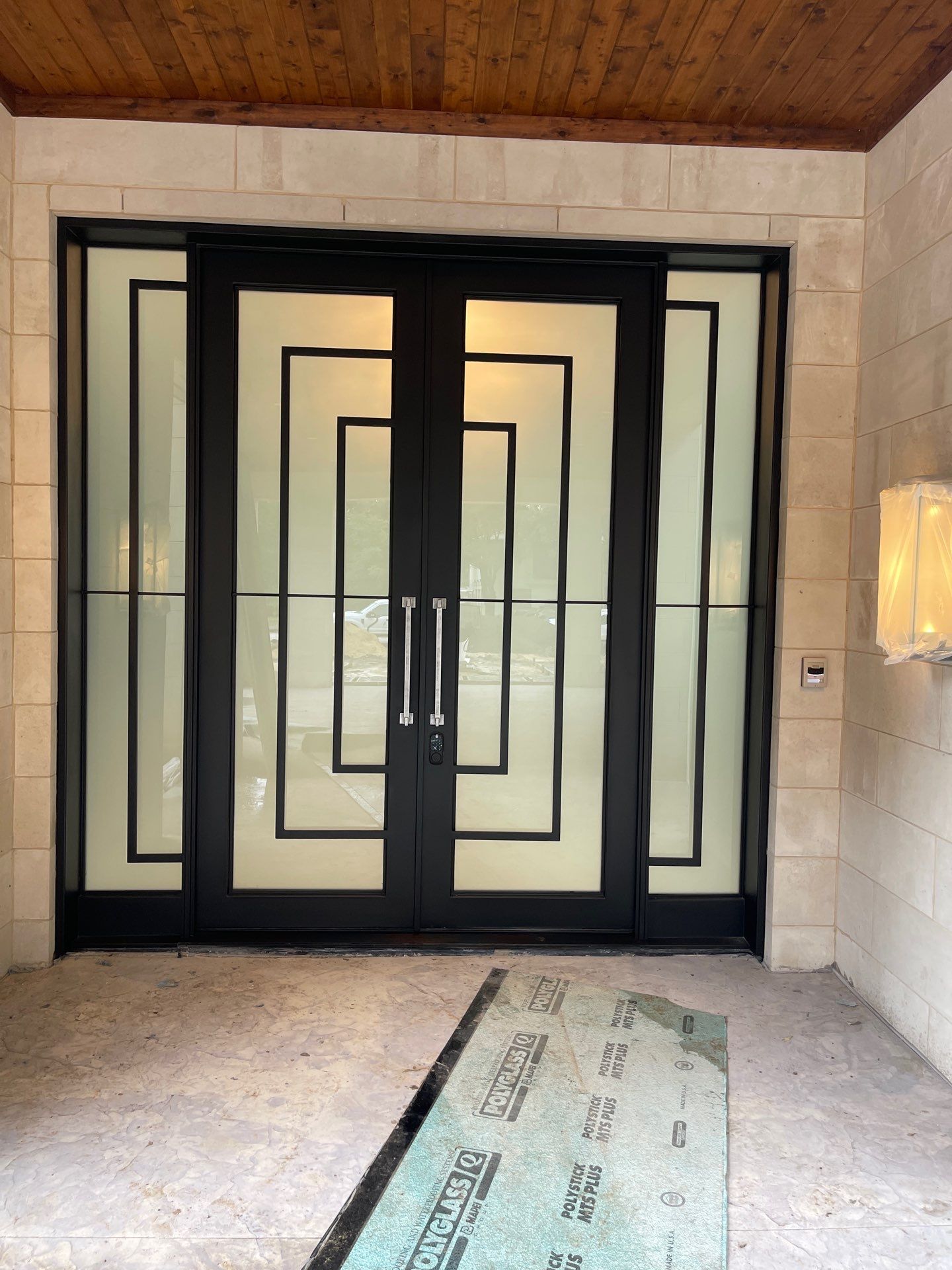 Modern Metal and Glass Entryway Installation with Custom Hardware Finishing in Dallas by Solara Custom Living