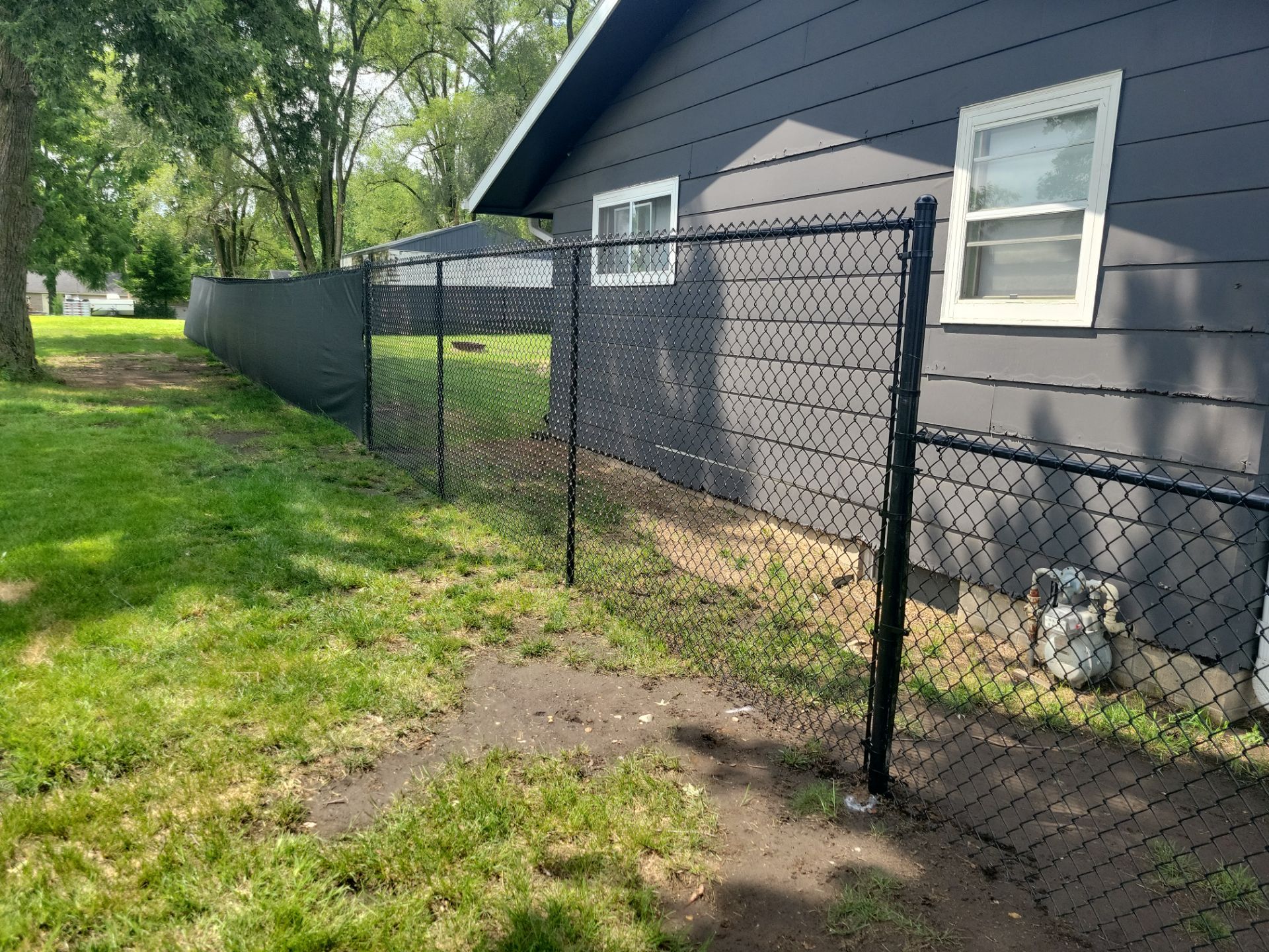 Black Chain Link Perimeter Fence Installation in Waterloo by Perfect Picket Fence and Stain
