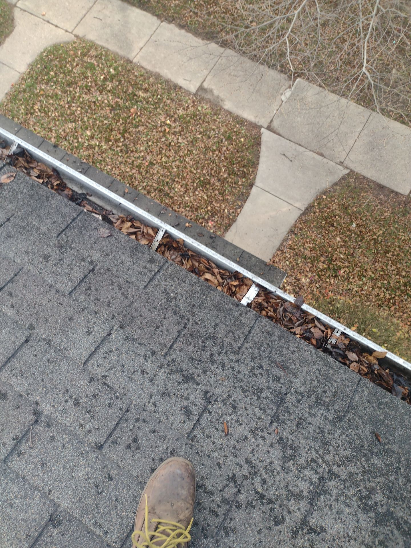 Commercial gutter cleaning Lansing before photo with filled gutters
