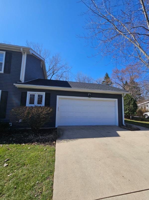 Asphalt Roof Replacement with Aluminum Gutter Installment by Custom Installations