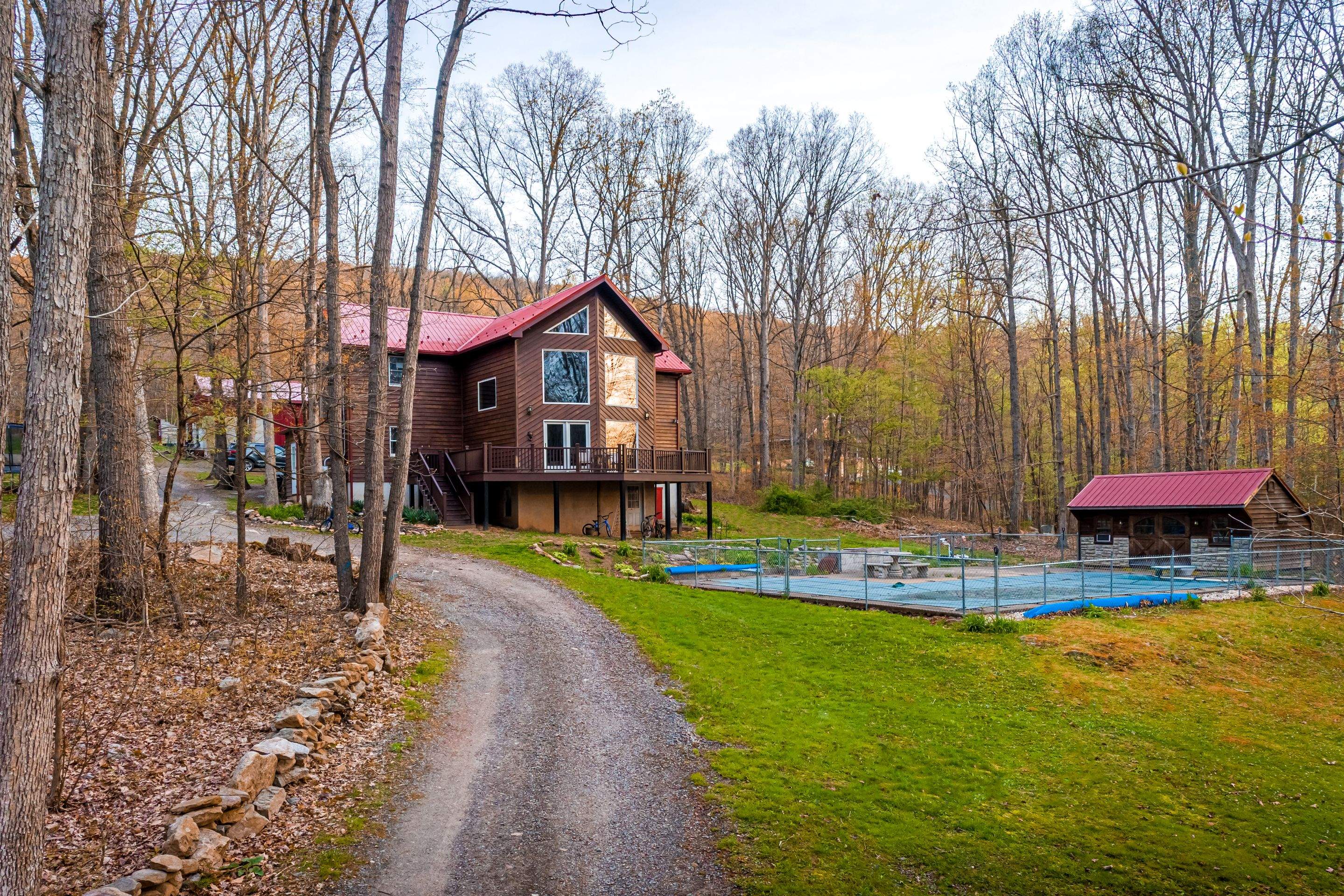 Metal Roof-barn red and new deck by Esh Builders