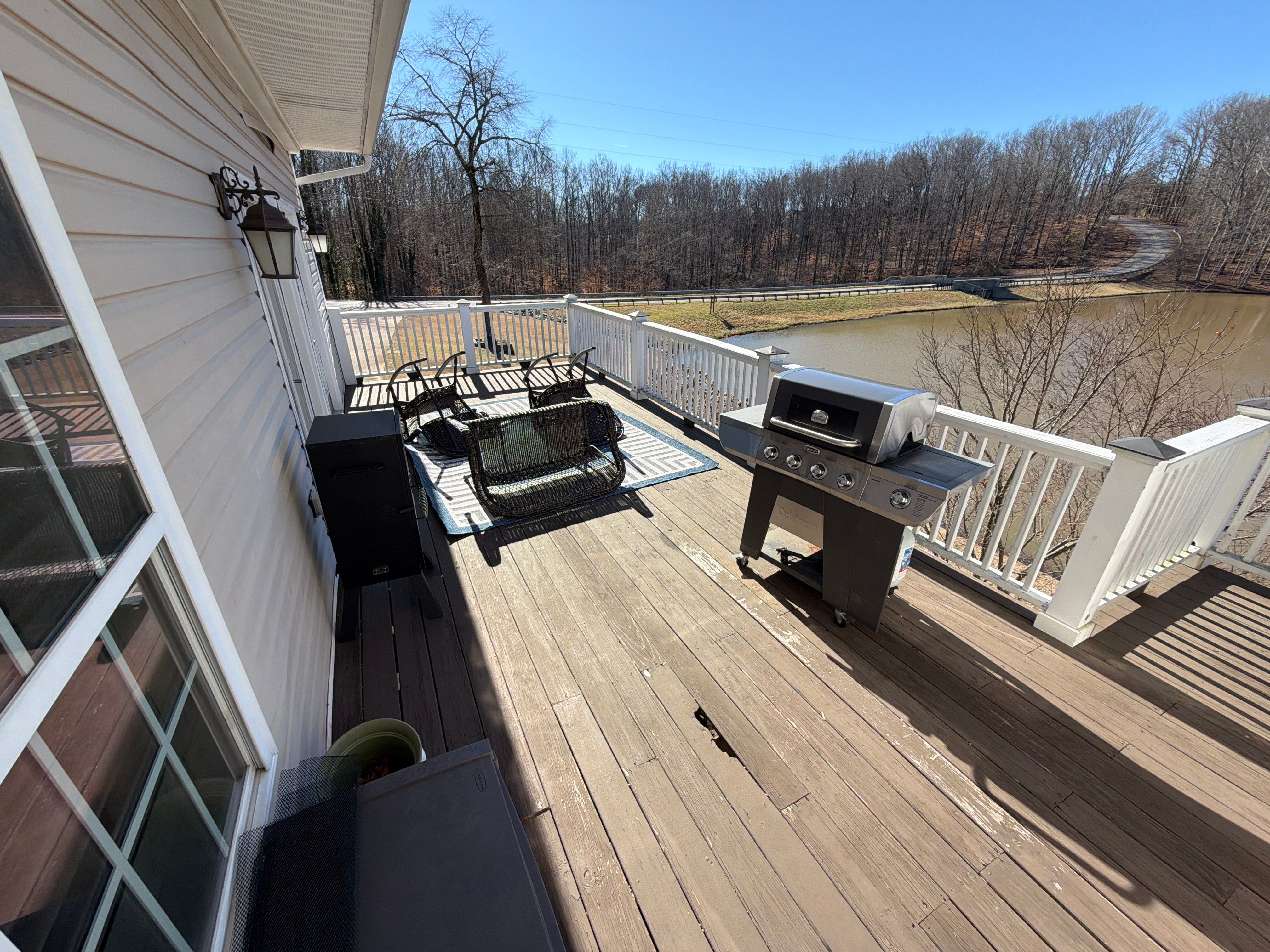 Cumming, GA Lake House Deck Resurface and Extension using Pressure Treated Pine and Skyline Cable Railing by Nelson Exteriors 
