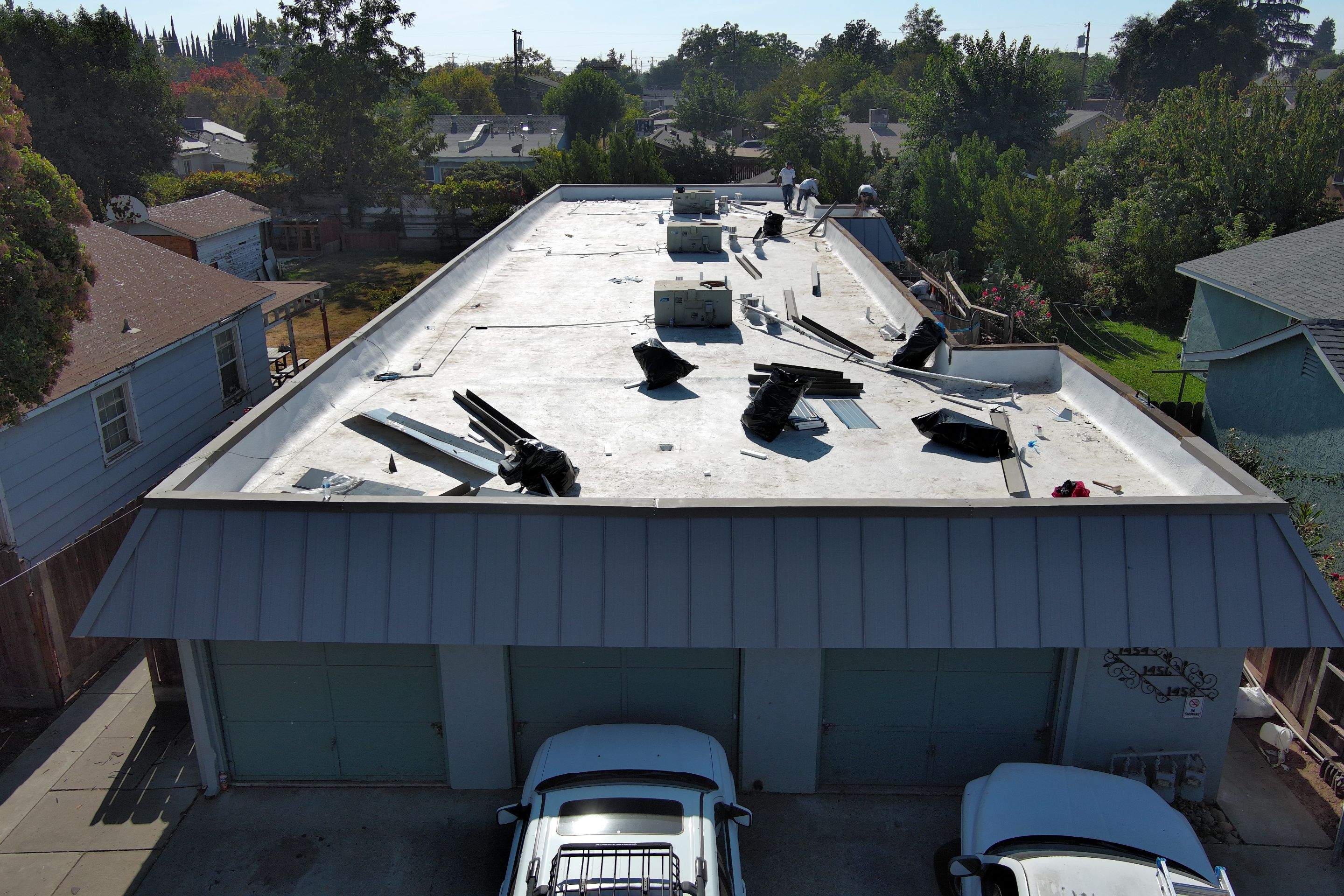 Foam Refurbish using Conklin Benchmark/PUMA XL coatings and spray foam; Also metal roofing around parapet wall by Straight Edge Roofing Inc