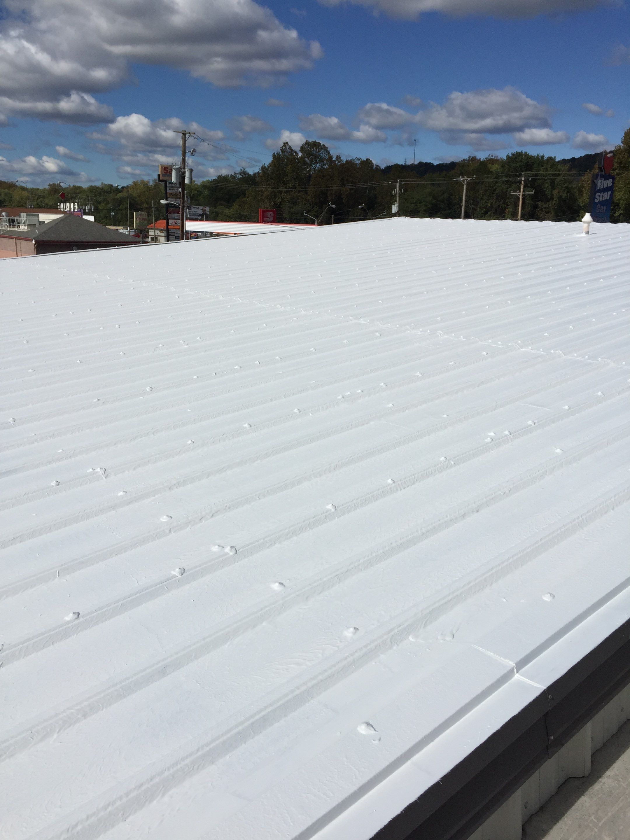 Commercial Roof Coating using Gaco Silicone Roof Coating by Secure Construction Company Inc