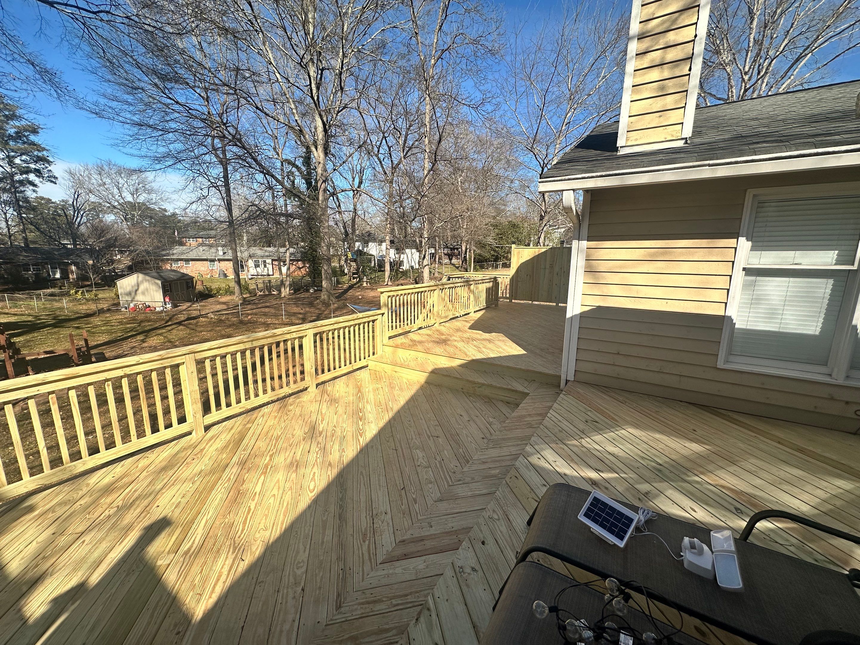 Elevated Pressure-Treated Wood Deck Extension in Marietta by Swift Home Renovations
