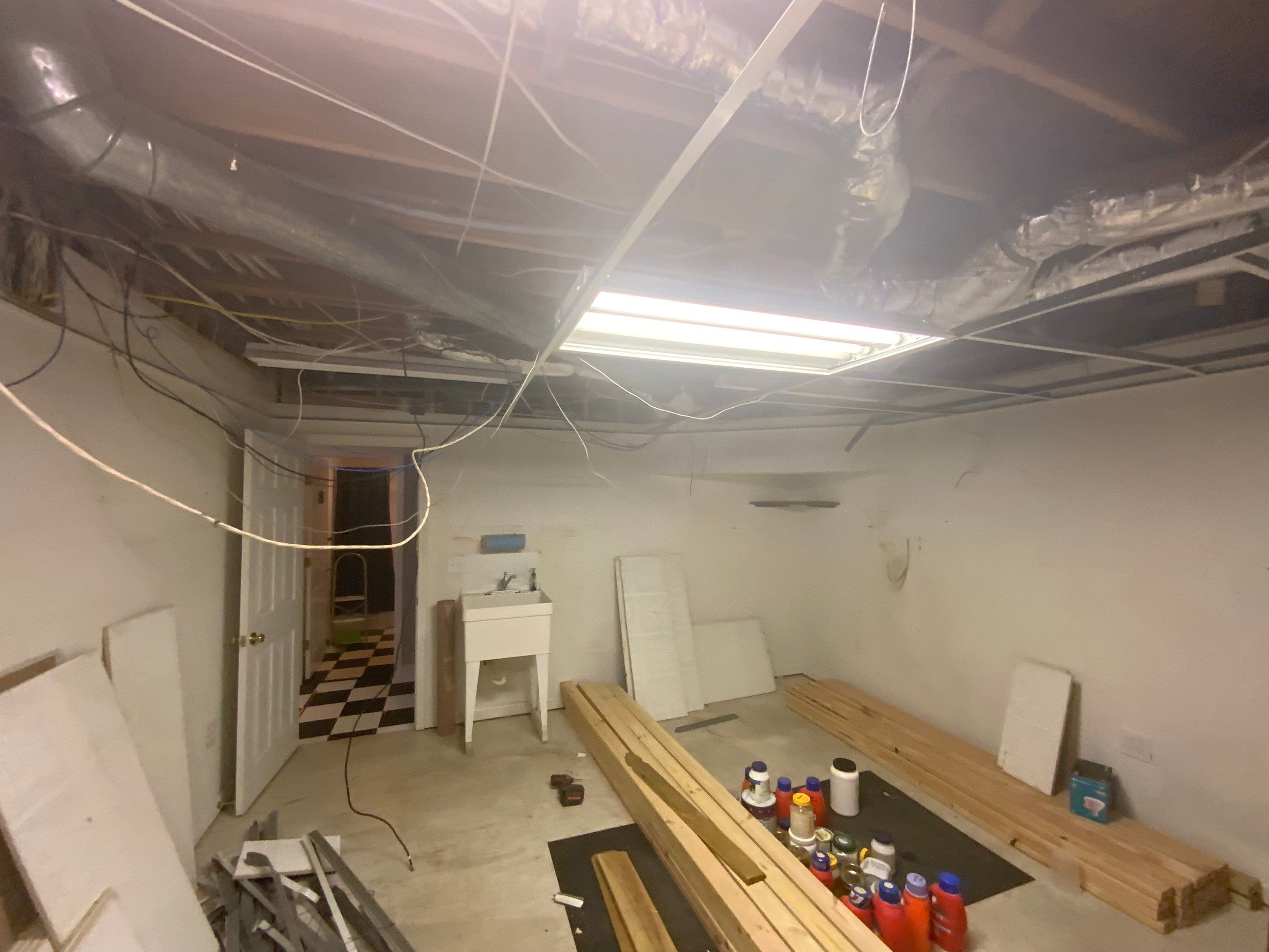 Finished Basement Room Transformation with Wood-Look Flooring in Roswell by Swift Home Renovations