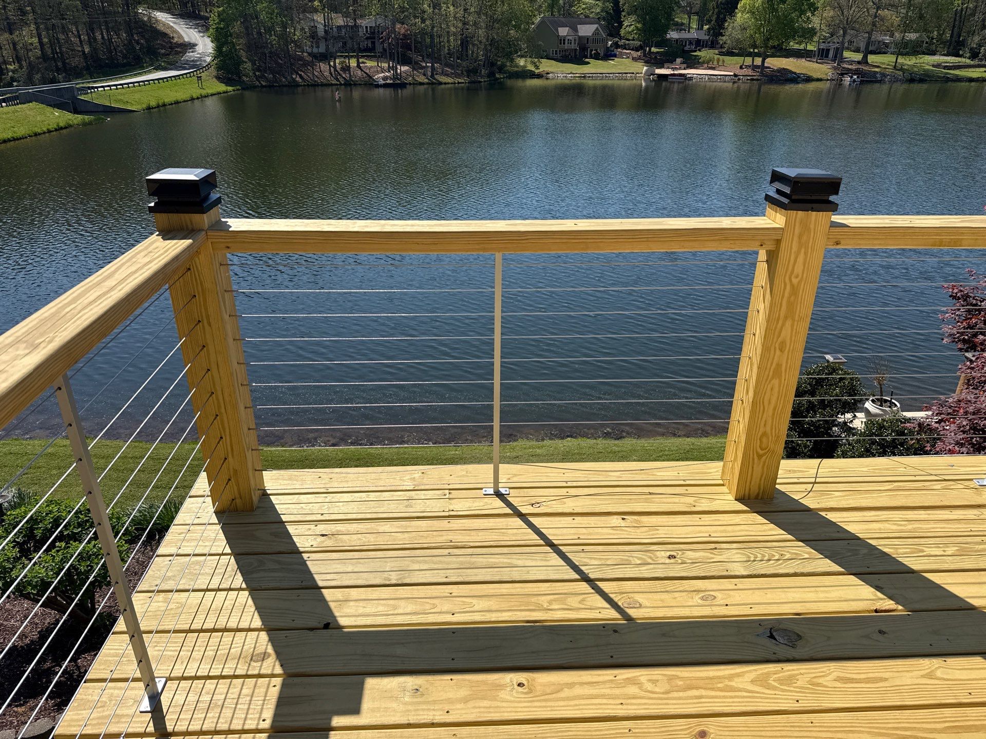 Cumming, GA Lake House Deck Resurface and Extension using Pressure Treated Pine and Skyline Cable Railing by Nelson Exteriors