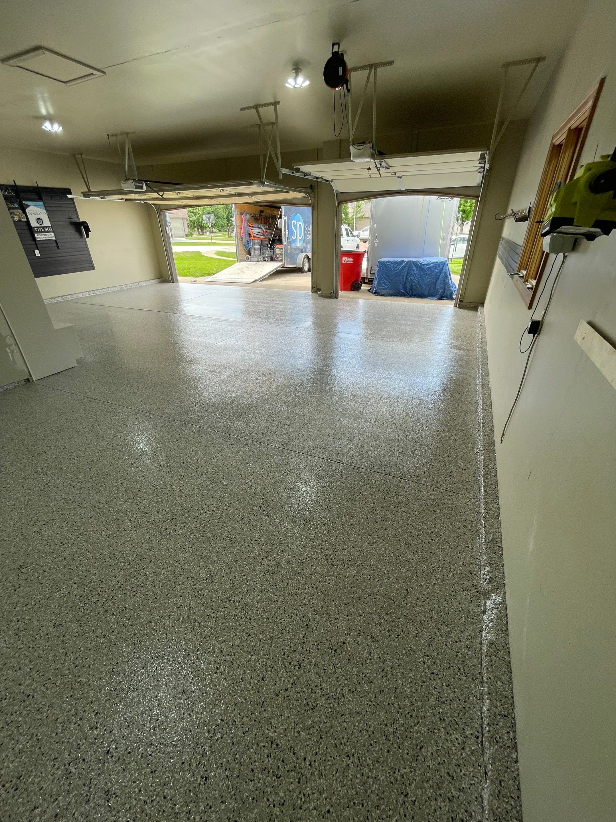 Cabin FEver Flake Garage Floor Coating Installation in Sioux Falls by Select Painting, Coatings & Garage Cabinets