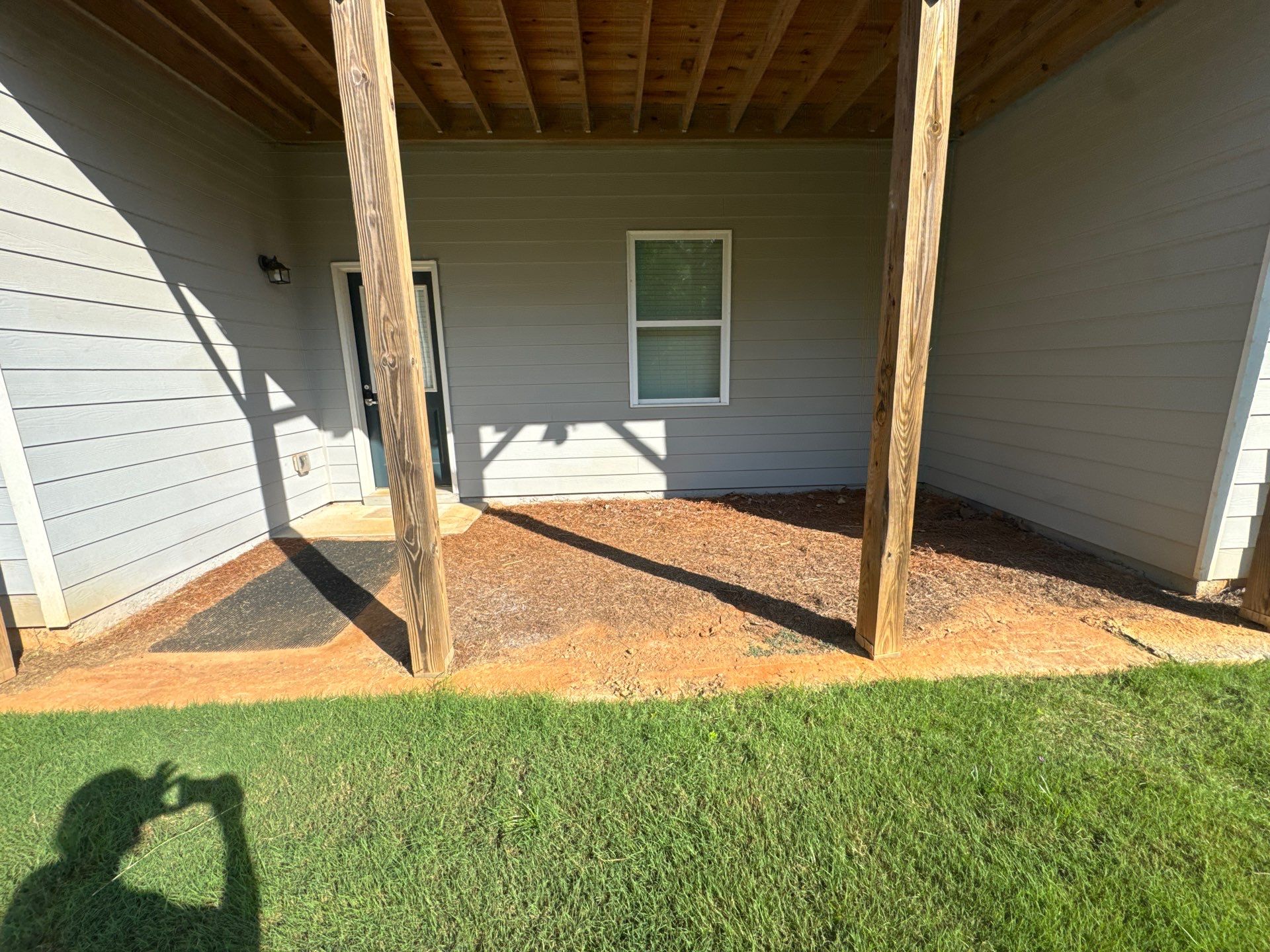 Ground-Level Gray Composite Deck and Privacy Fence Installation by Swift Home Renovations