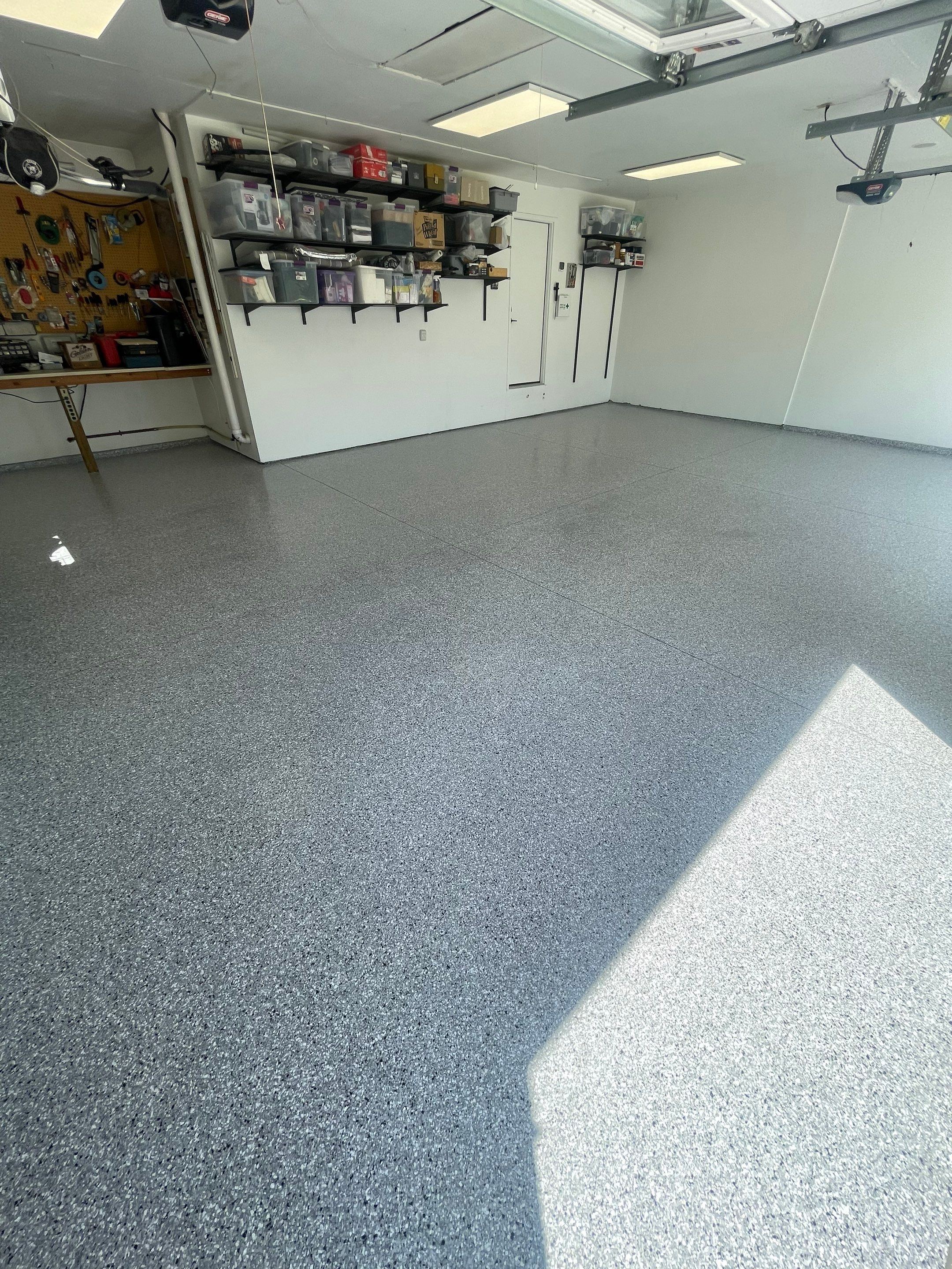 Feather Grey Garage Floor Coating Installation in Sioux Falls by Select Painting, Coatings & Garage Cabinets