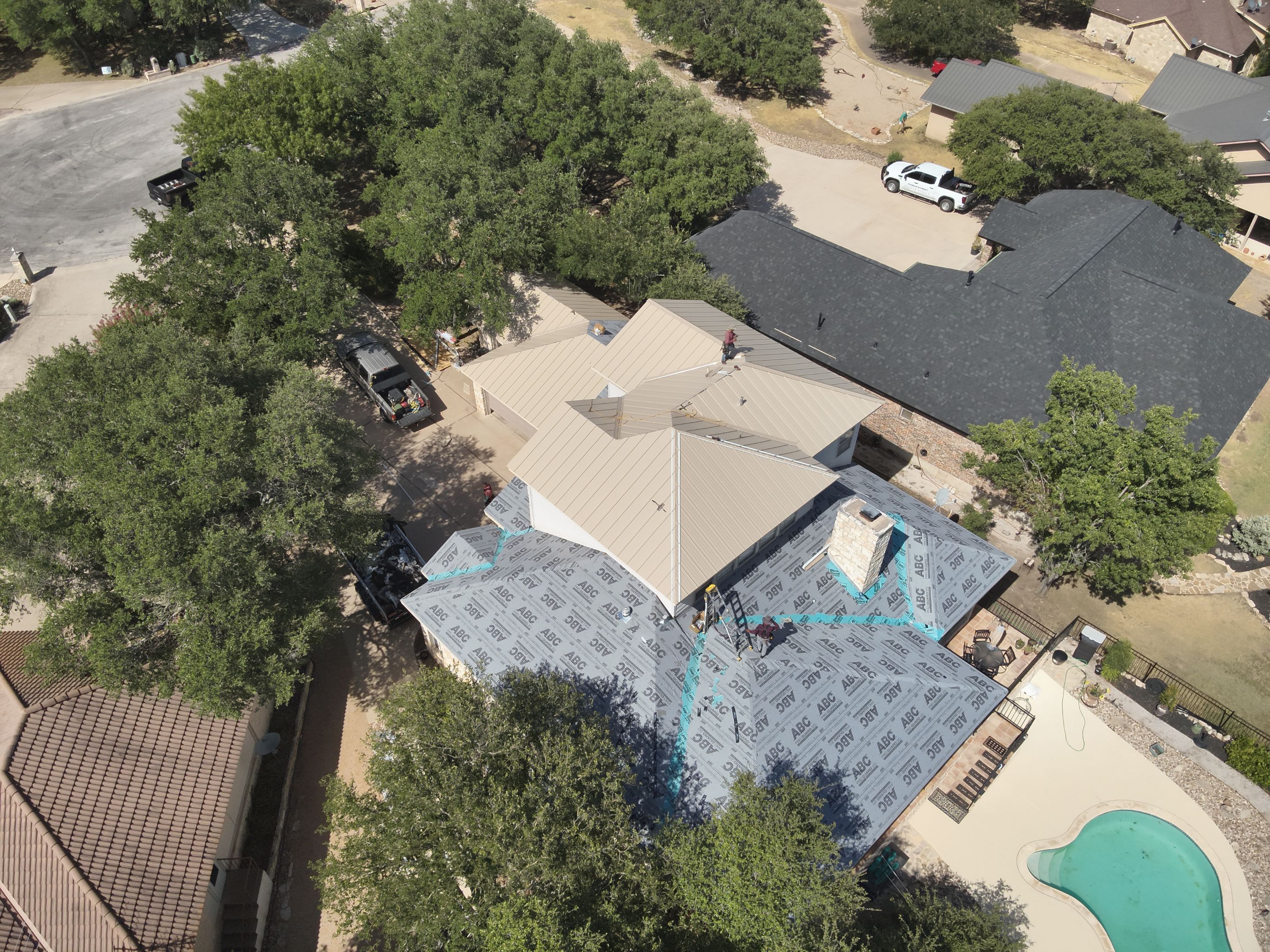 Residential Roof Replacement using 24 GA Double-Lock - Surrey Beige by Action Exteriors Austin