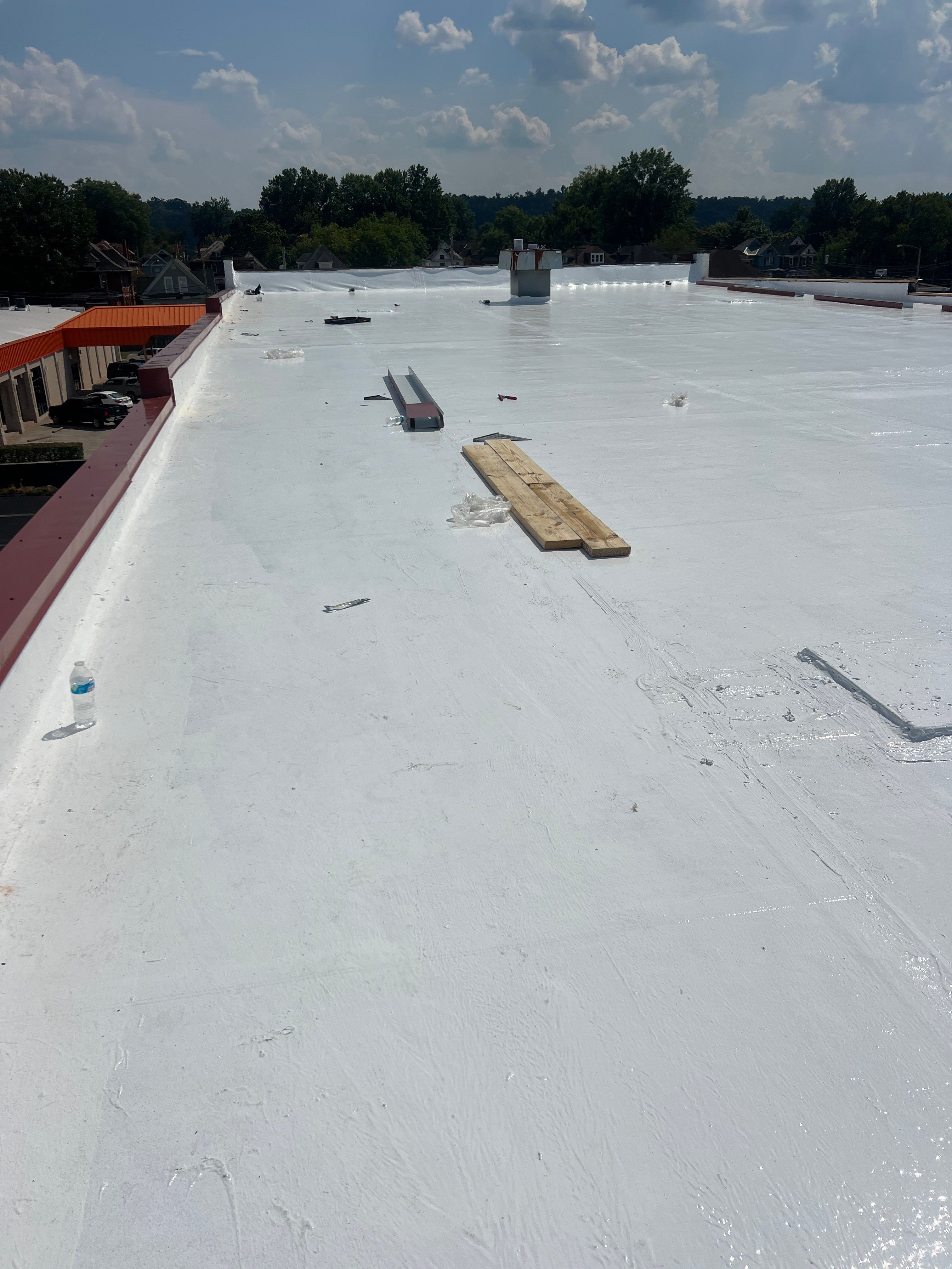 Commercial Roofing Installation using smartcoat Roof coating by Fahey Roofing + Contracting