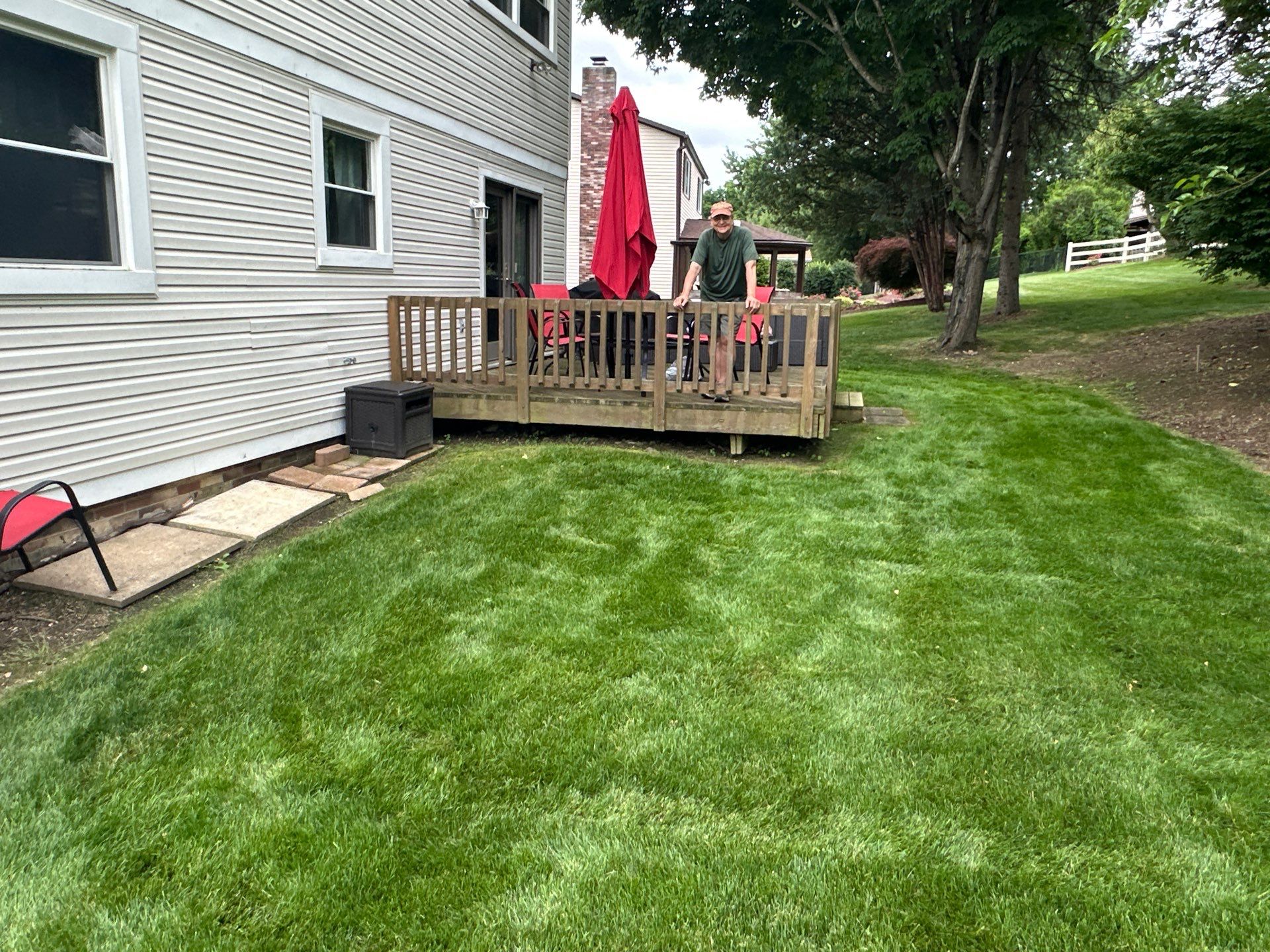 Bridgeville Composite Deck Build with White Railings and Versalok Retaining Wall by Cousins Roofing Siding & Decks