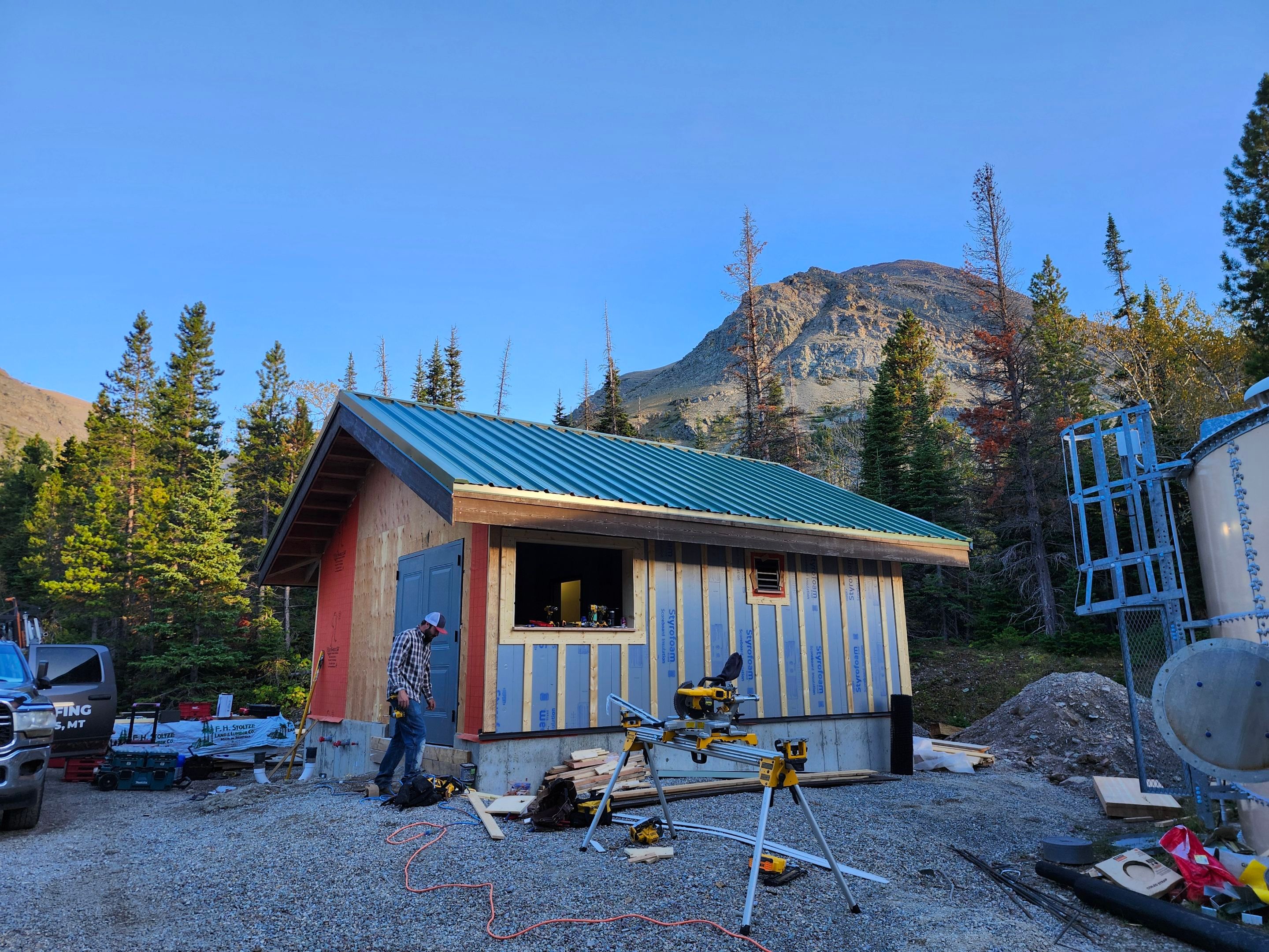 Green Standing Seam Metal Roof Installation in East Glacier Park by KQC Roofing