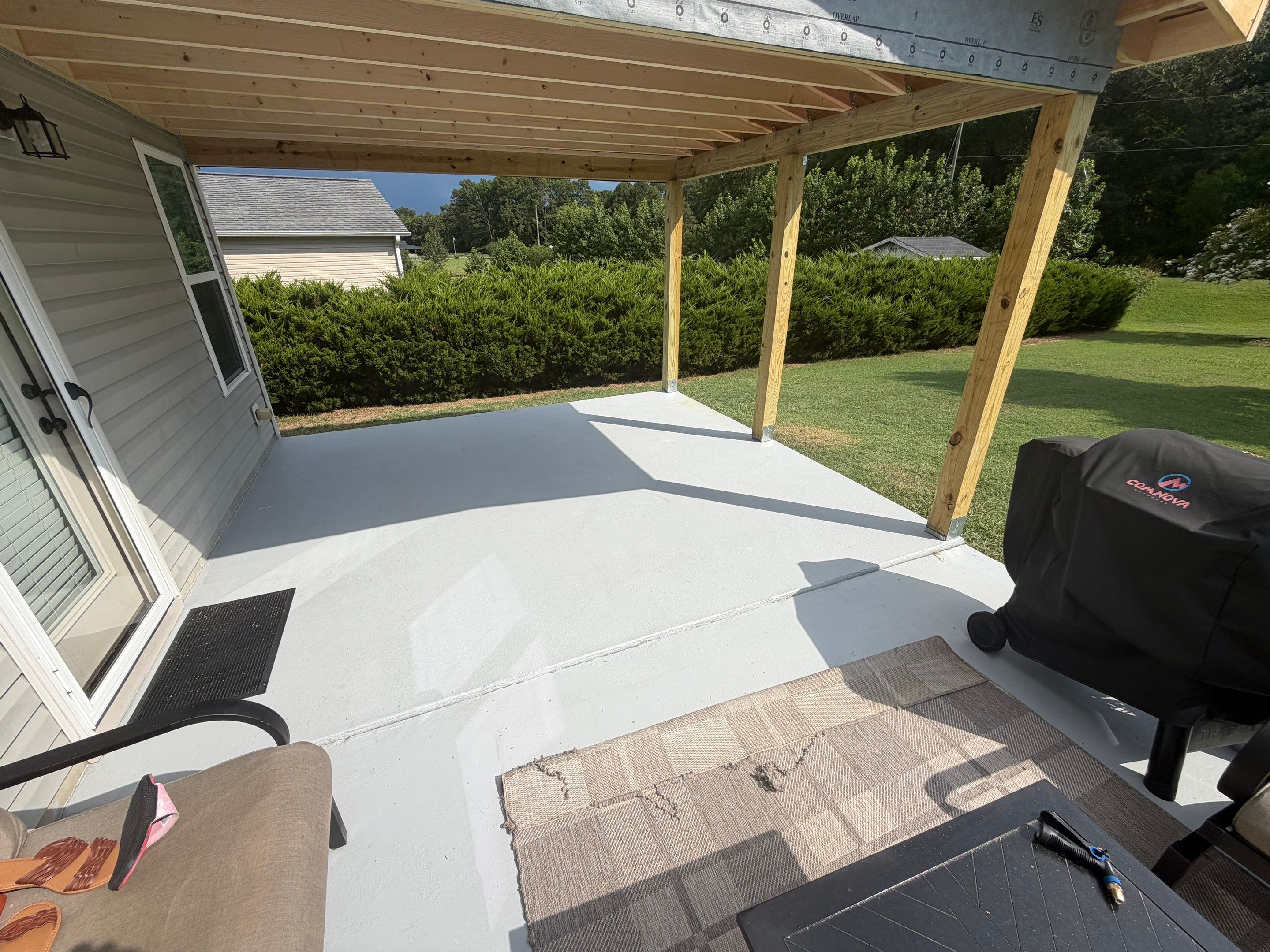 Covered Patio Roof Construction with Architectural Shingles in Garner by The Remodeling Company