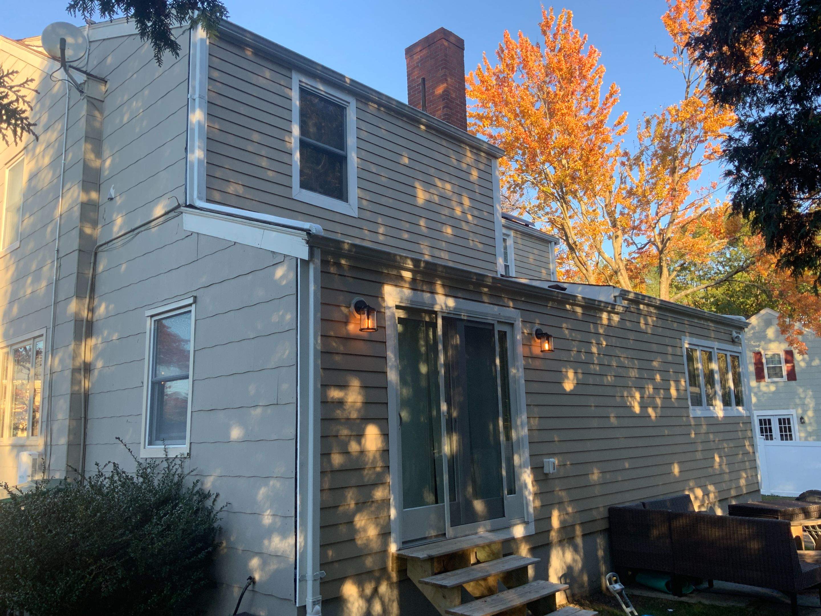 James Hardie siding, new metal roof and couple windows being installed. by UBrothers Construction
