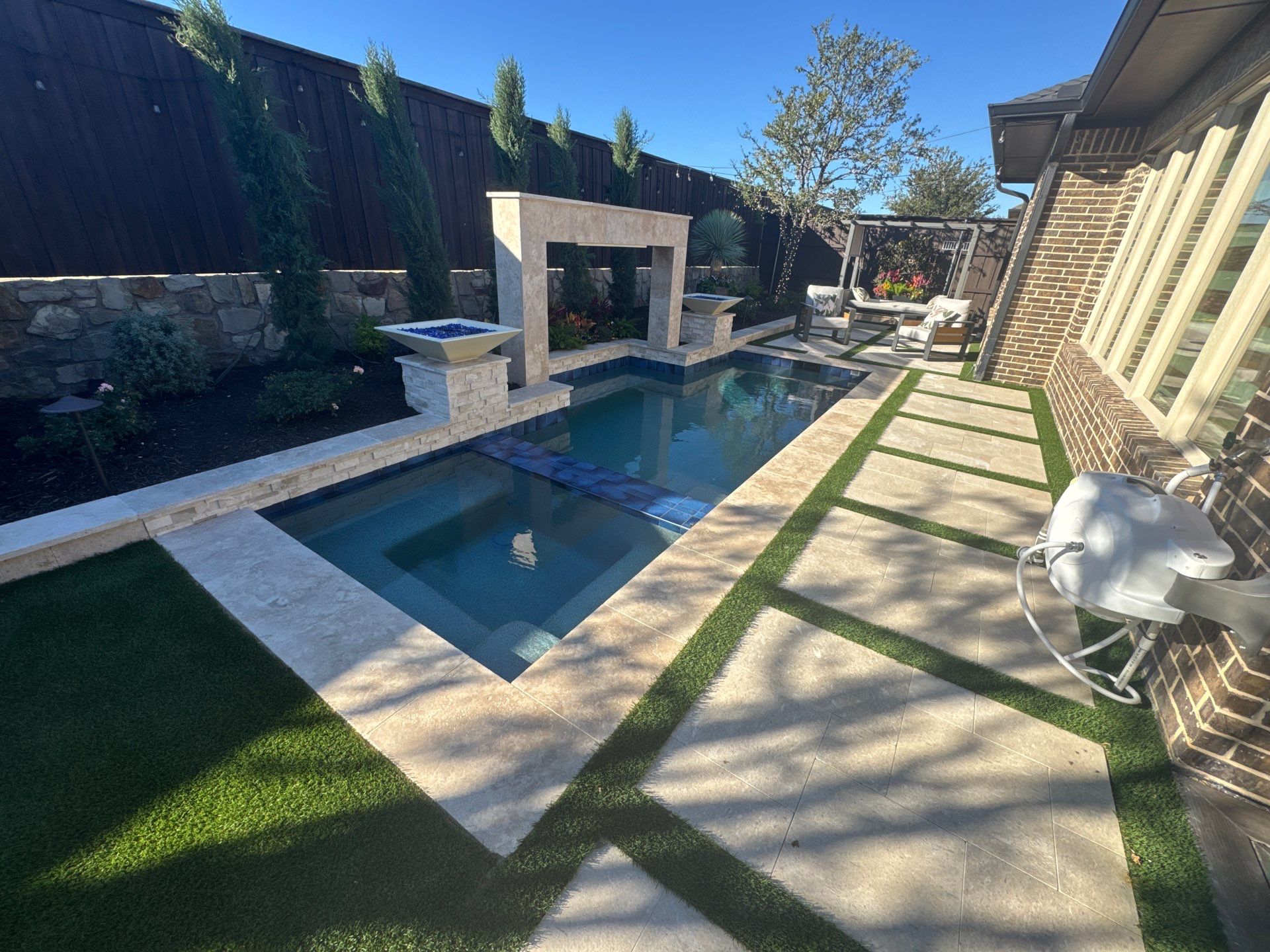 Modern Pool with Raised Water Feature Wall by Pinnacle Pools and Spas - DFW