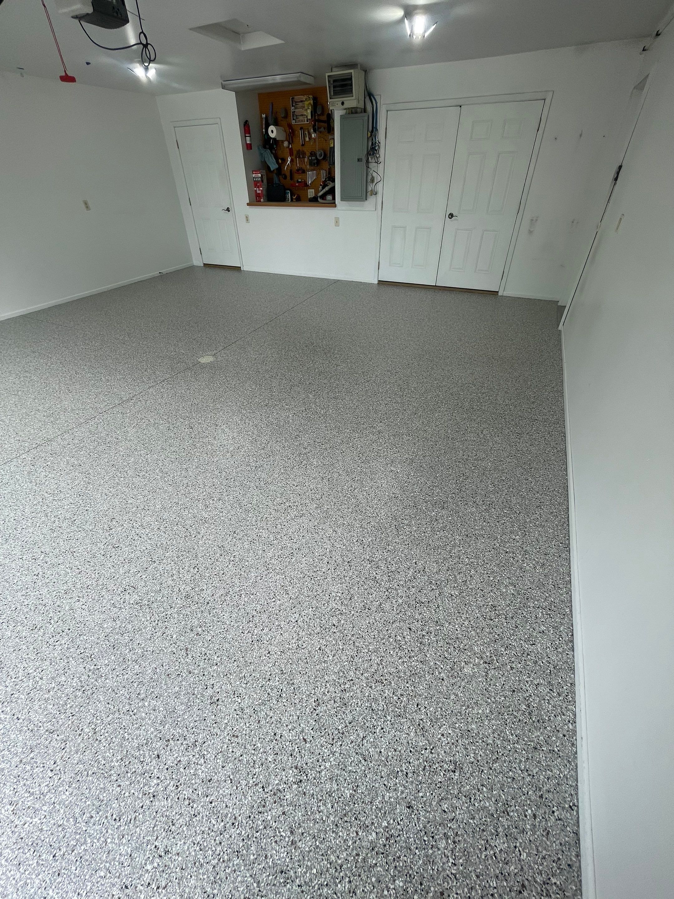 Coyote Flake Garage Floor Coating in Worthington, Minnesota by Select Painting, Coatings & Garage Cabinets