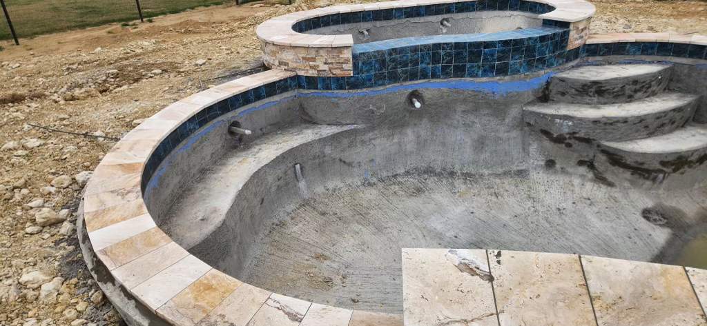 Freeform Pool with Raised Spa and Travertine Decking by Pinnacle Pools and Spas - DFW