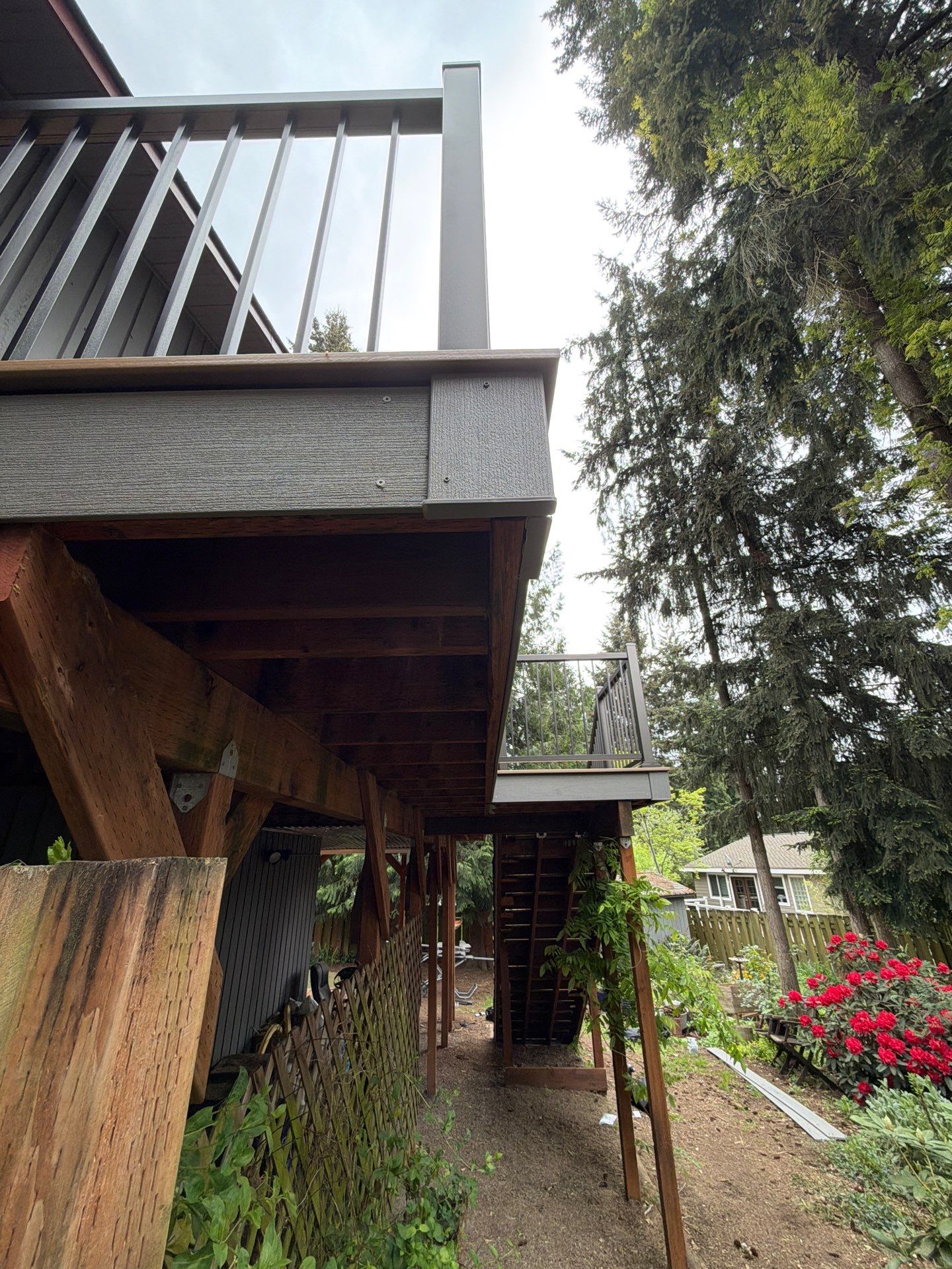 Elevated TimberTech Composite Deck Replacement With Black Metal Railings by Emerald City Energy