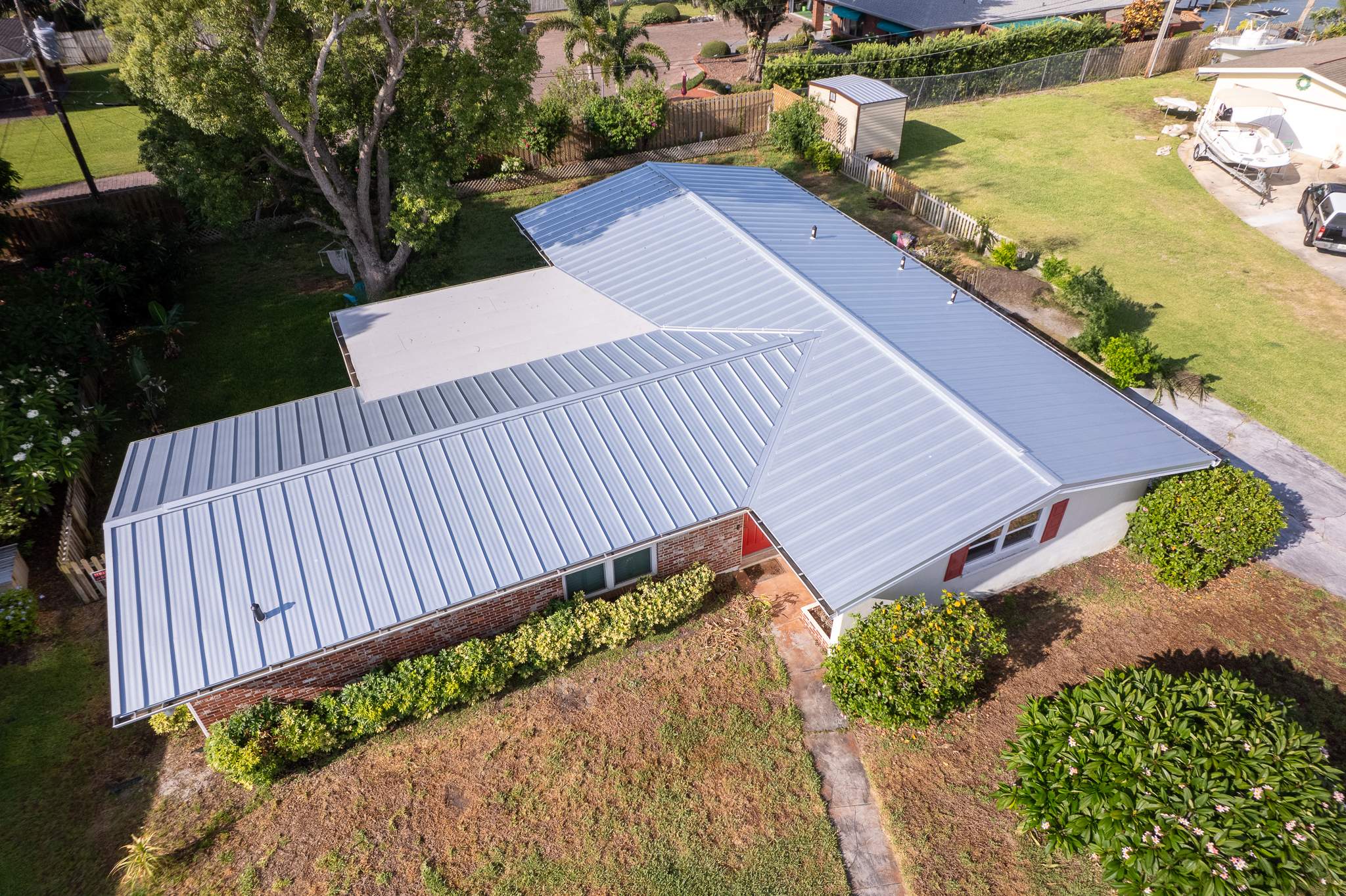 Standing Seam Metal Roof Replacement and New Gutters in Merritt Island by Wiedmann Construction & Roofing
