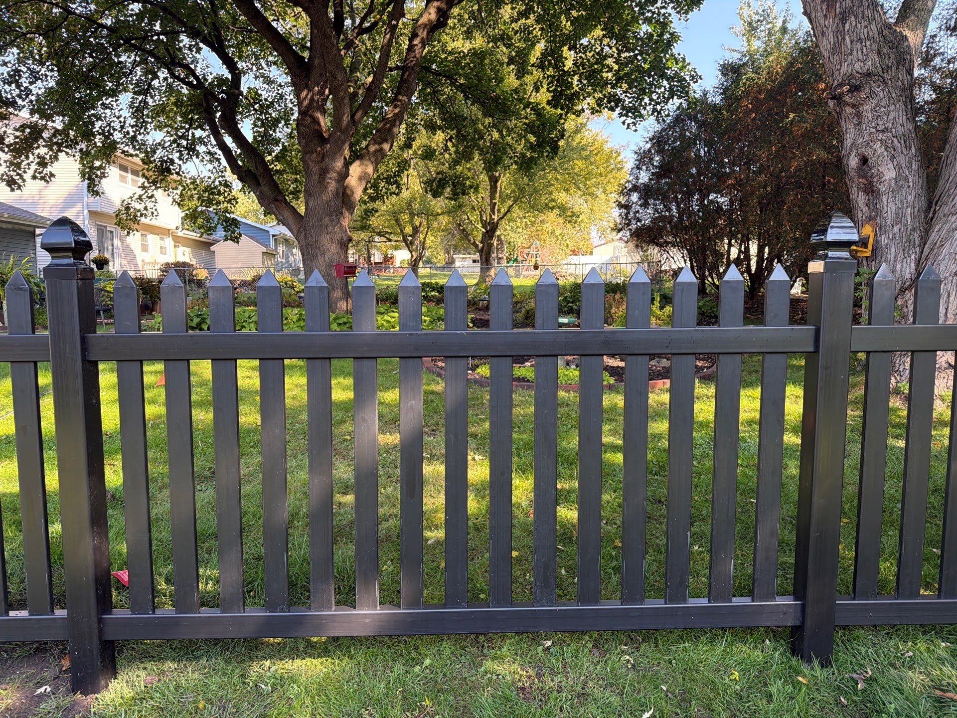 Black Vinyl Spaced Picket Fence Installation in Cedar Falls by Perfect Picket Fence and Stain