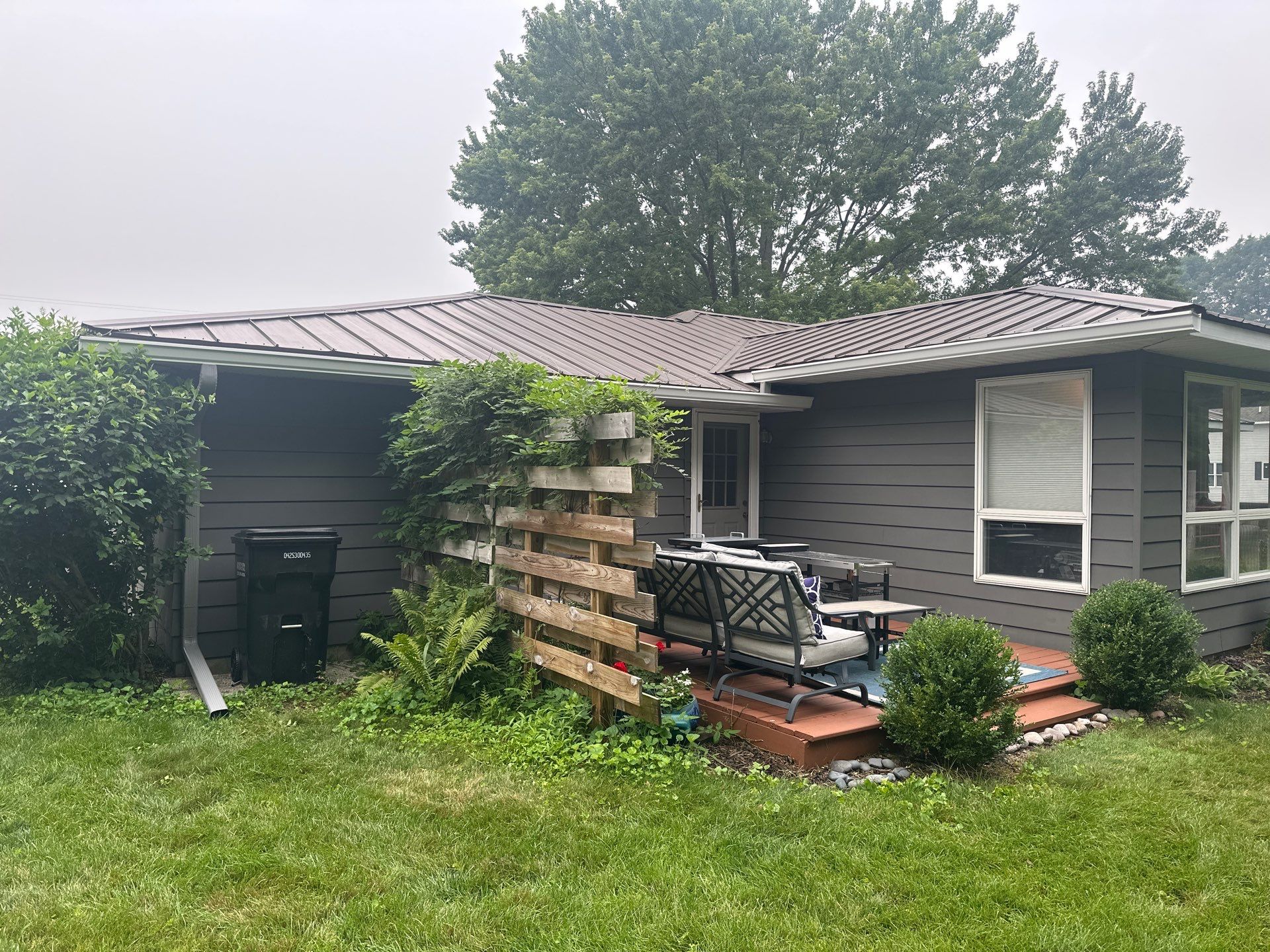 Gutter Installation for Onekama Residence With Metal Roofing by Rainbow Seamless Systems