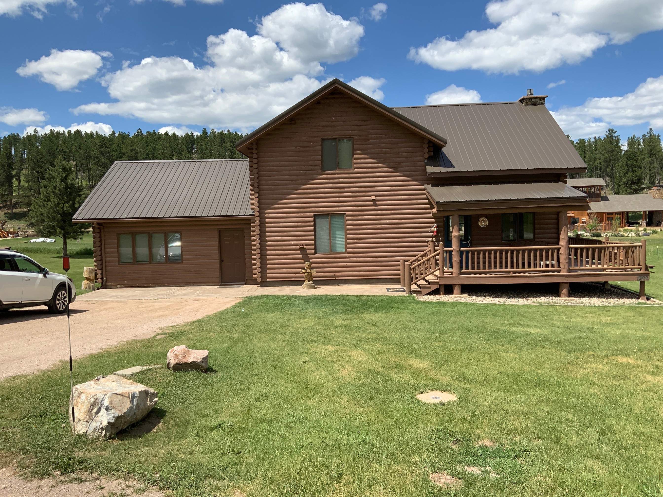 Hill Country Guest Ranch using Steel Roofing, Gutters, Log Cabin Staining by Lightning Exteriors